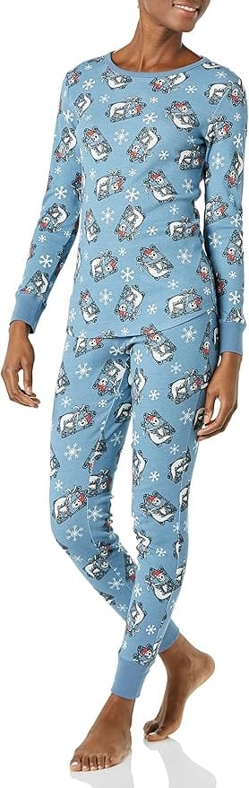 Person wearing blue Disney pajamas with a pattern of Jack Skellington and snowflakes.