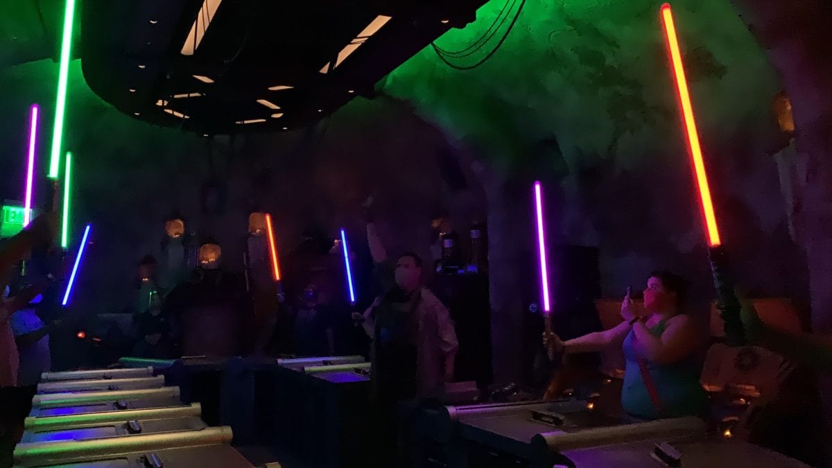 Visitors wield colorful lightsabers at Savi's Workshop in Disneyland Resort.