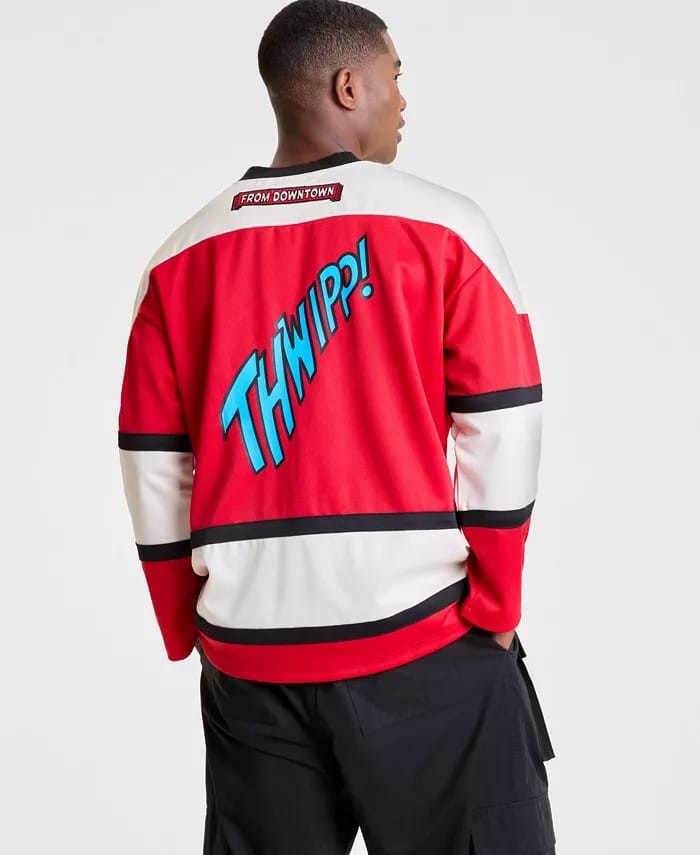 A man wearing a red and white Spider-Man "THWIPP!" jersey stands with his back to the camera, as seen in many Disney Parks.