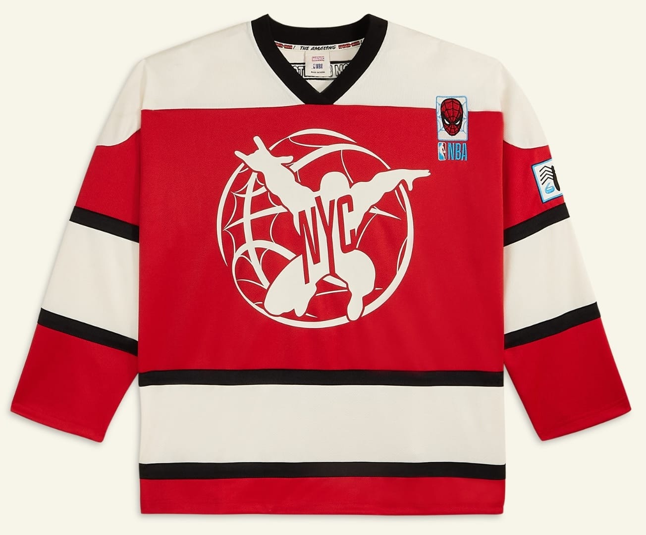 Red and white hockey jersey with black stripes, Spider-Man NYC graphic, Macy's NBA and Spider-Man patches—no Disney castle like in the parks.