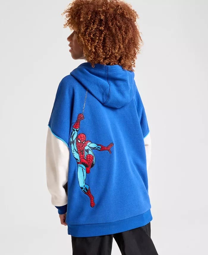 Park guest in a blue Macy's hoodie with Spider-Man graphic on the back, facing away, reminiscent of Marvel gear at Disney parks.