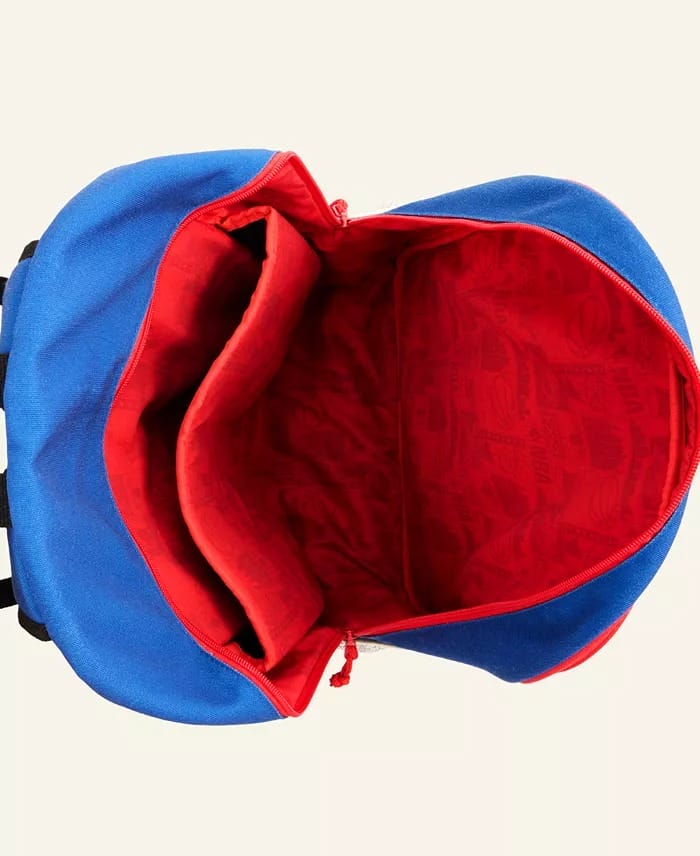 Open blue and red Spider-Man backpack at a Disney park, viewed from above with its empty main compartment and inner pocket visible.