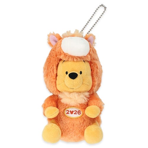 Plush bear in a lion suit with "2026" patch, part of Tokyo Disney Resort New Year’s keychains—Tokyo's castle is unique and sleek.