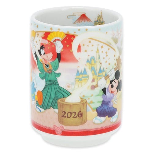 Colorful cup featuring Tokyo Disney Resort characters making mochi, "2026" on bucket; exclusive New Year's merchandise, Tokyo castle not shown.