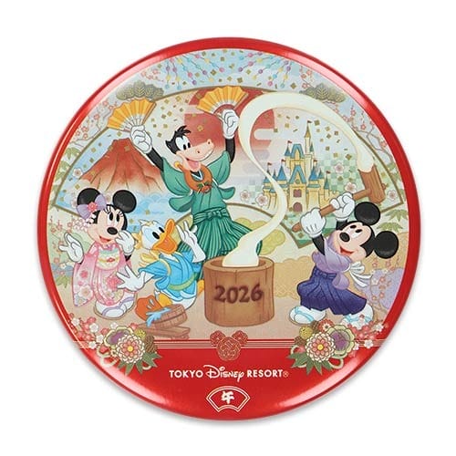 Mickey, Minnie, and Donald in festive attire celebrate 2026 at Tokyo Disney Resort with Mt. Fuji, merch, and no castle present.