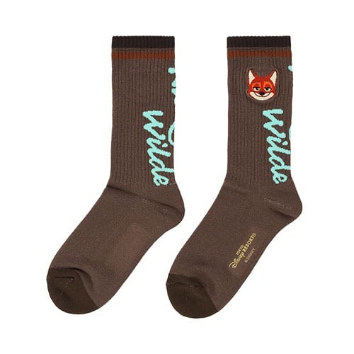 Brown socks with a fox face and "wilde" in blue script; Zootopia 2 Disney Parks merch, Disney logo on the sole. No castle shown.