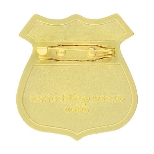Gold badge pin with Tokyo Disneyland and Tokyo Disney Resort ©Disney engraved on back, representing Tokyo's unique park identity.