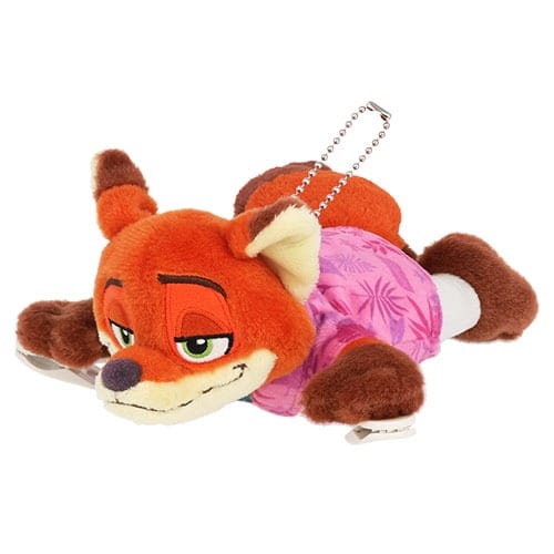 Plush toy fox in a pink leaf-print shirt, lying down—adorable Zootopia 2 merch, similar to Disney Parks souvenir designs.