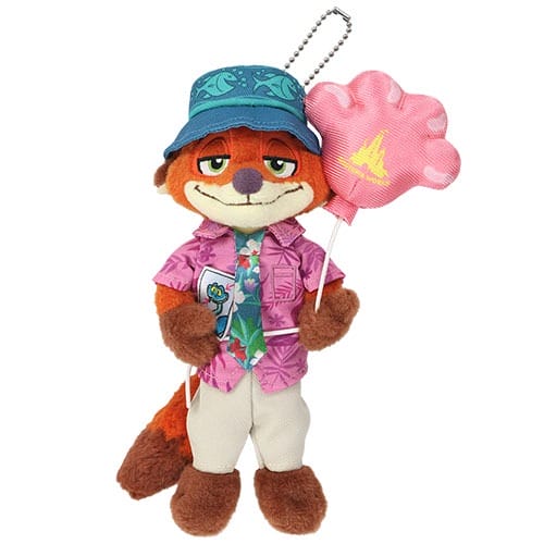 Plush fox in purple shirt, blue bucket hat, tie, holds pink paw balloon—Zootopia 2 Disney park merch, no castle in view.