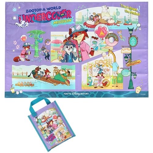 Colorful "Zootopia World Undercover Mission" game mat and Zootopia 2 merchandise, with a blue tote bag—classic Disney Parks style.