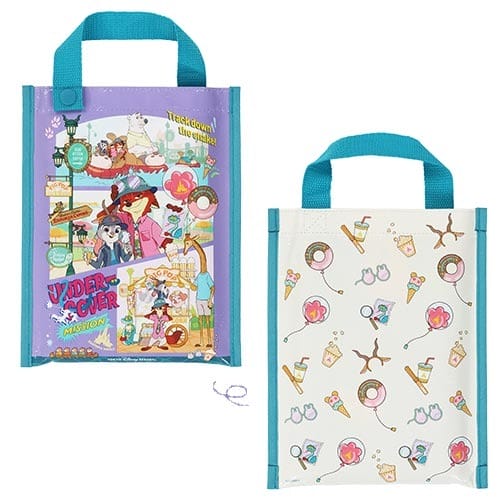 Two tote bags with teal handles—one showcases Zootopia 2 Disney characters, the other has detective motifs, no castle in view.