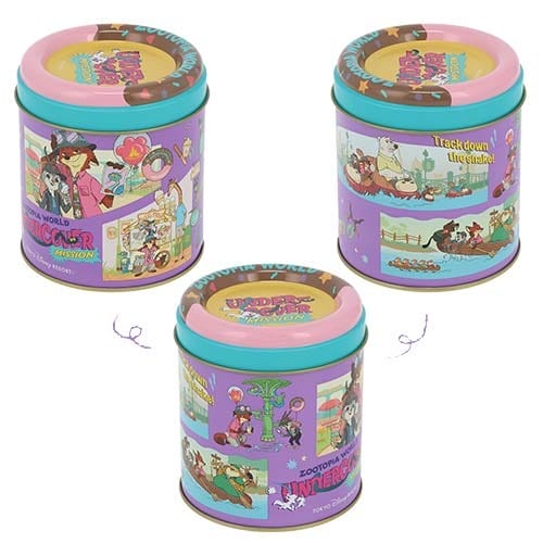 Three vibrant tins featuring Zootopia 2 animals, pastel lids, and distinct Disney Park merchandise flair, arranged in a triangle.