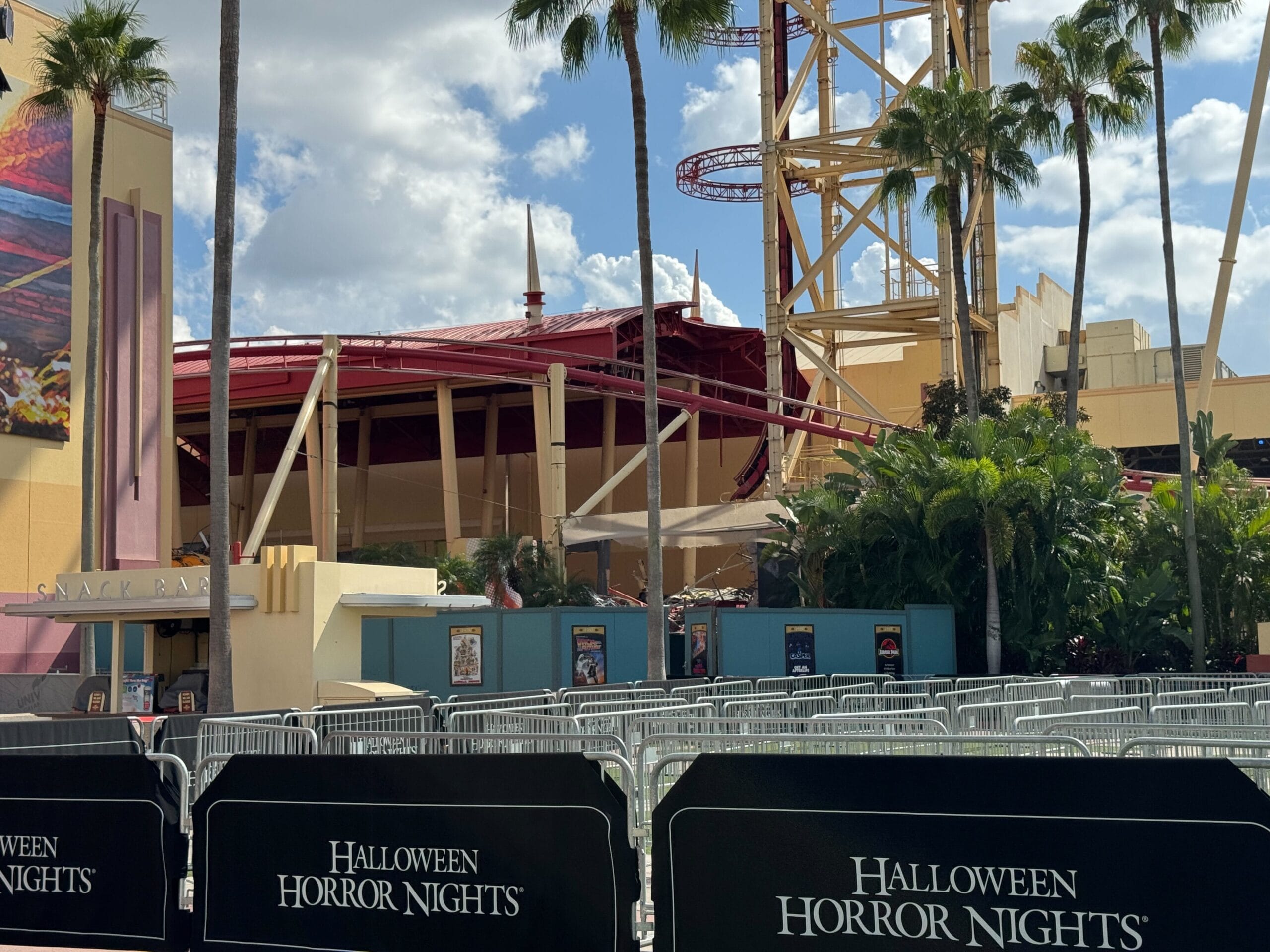Metal barricades labeled "Halloween Horror Nights" are set up at Hollywood Rip Ride Rockit in Universal Studios Florida.