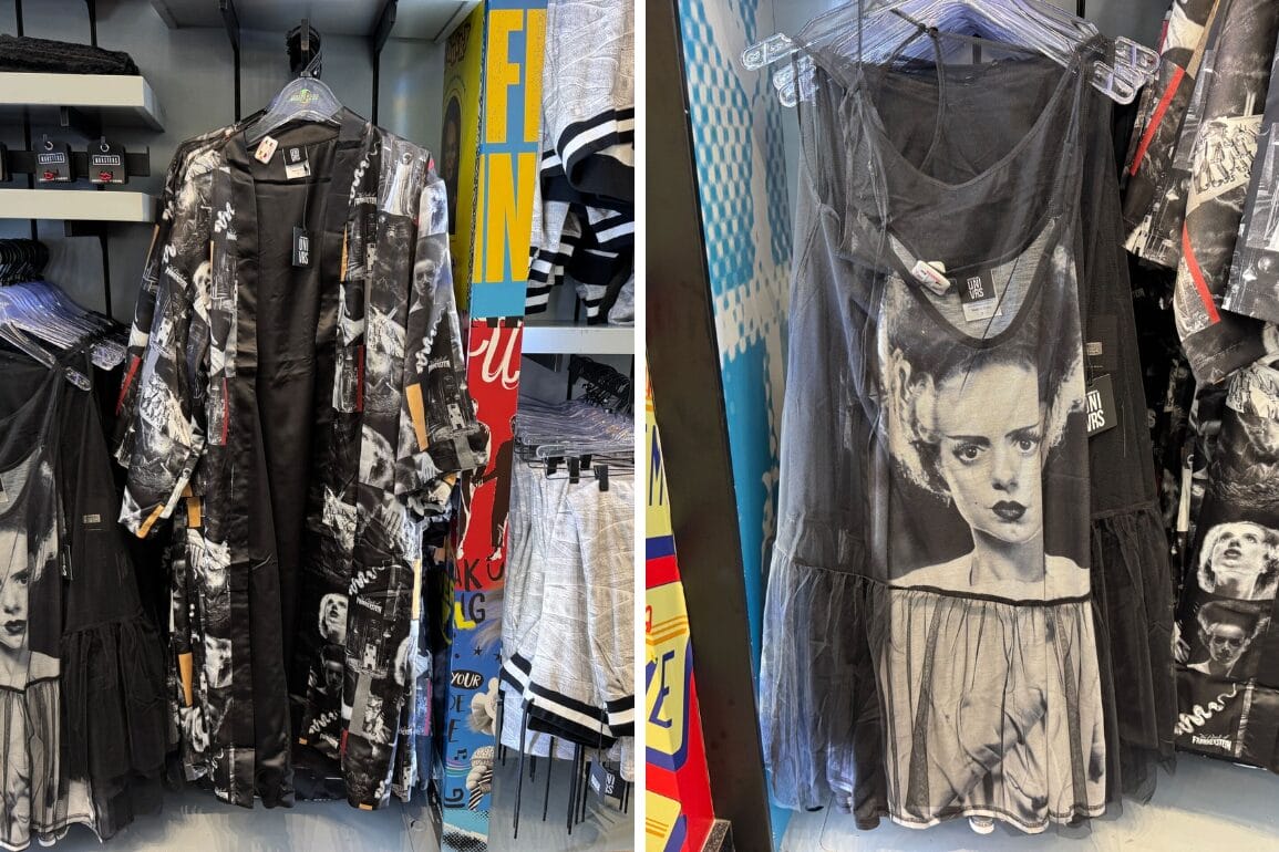 Bride of Frankenstein dress and other black horror-print clothes hang on racks—Universal merch with none of the Disney castle flair.