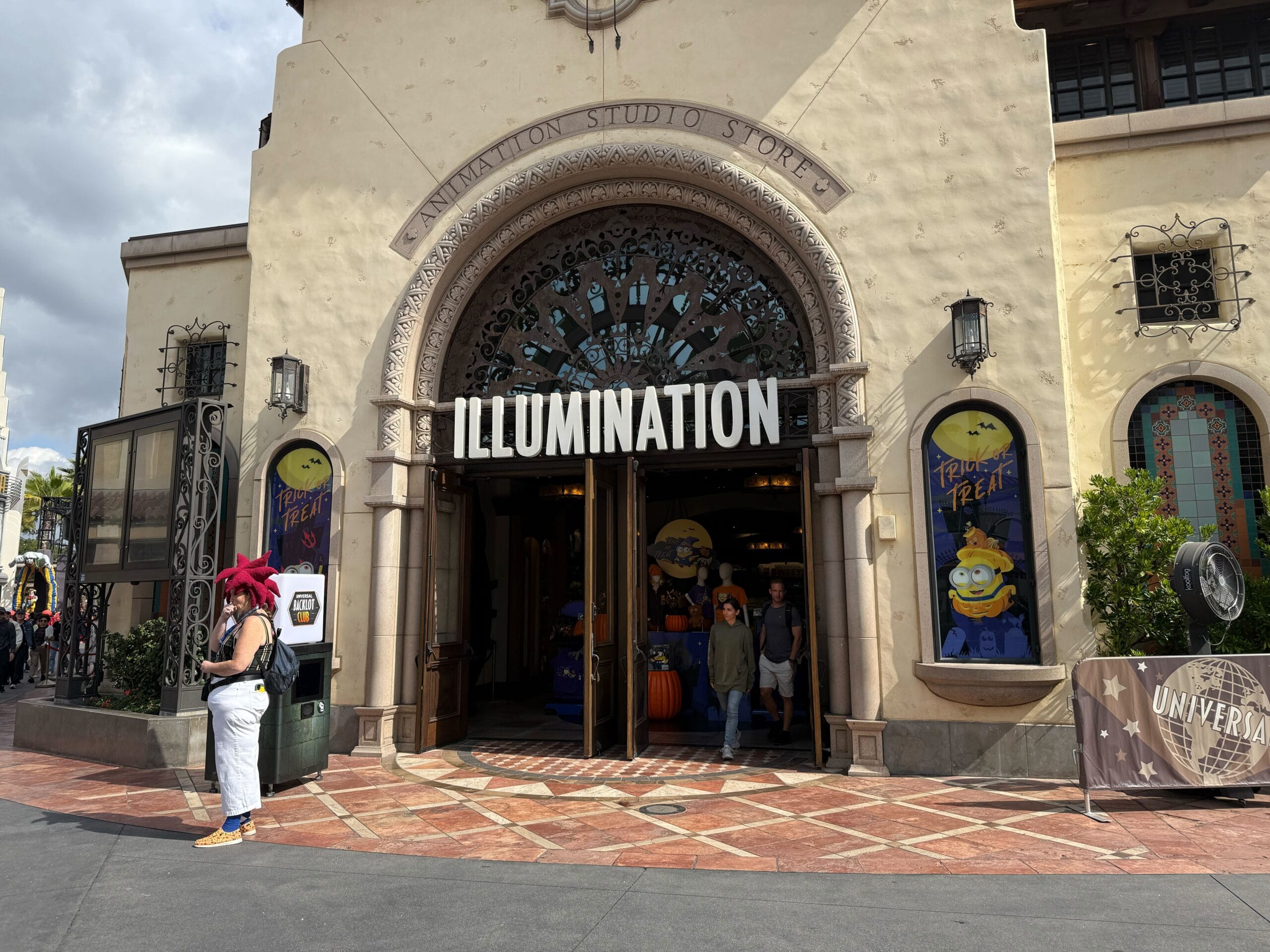 Entrance of Illumination store with Minion posters and Japan-themed decor, unlike the iconic Disney castle entrances at global parks.