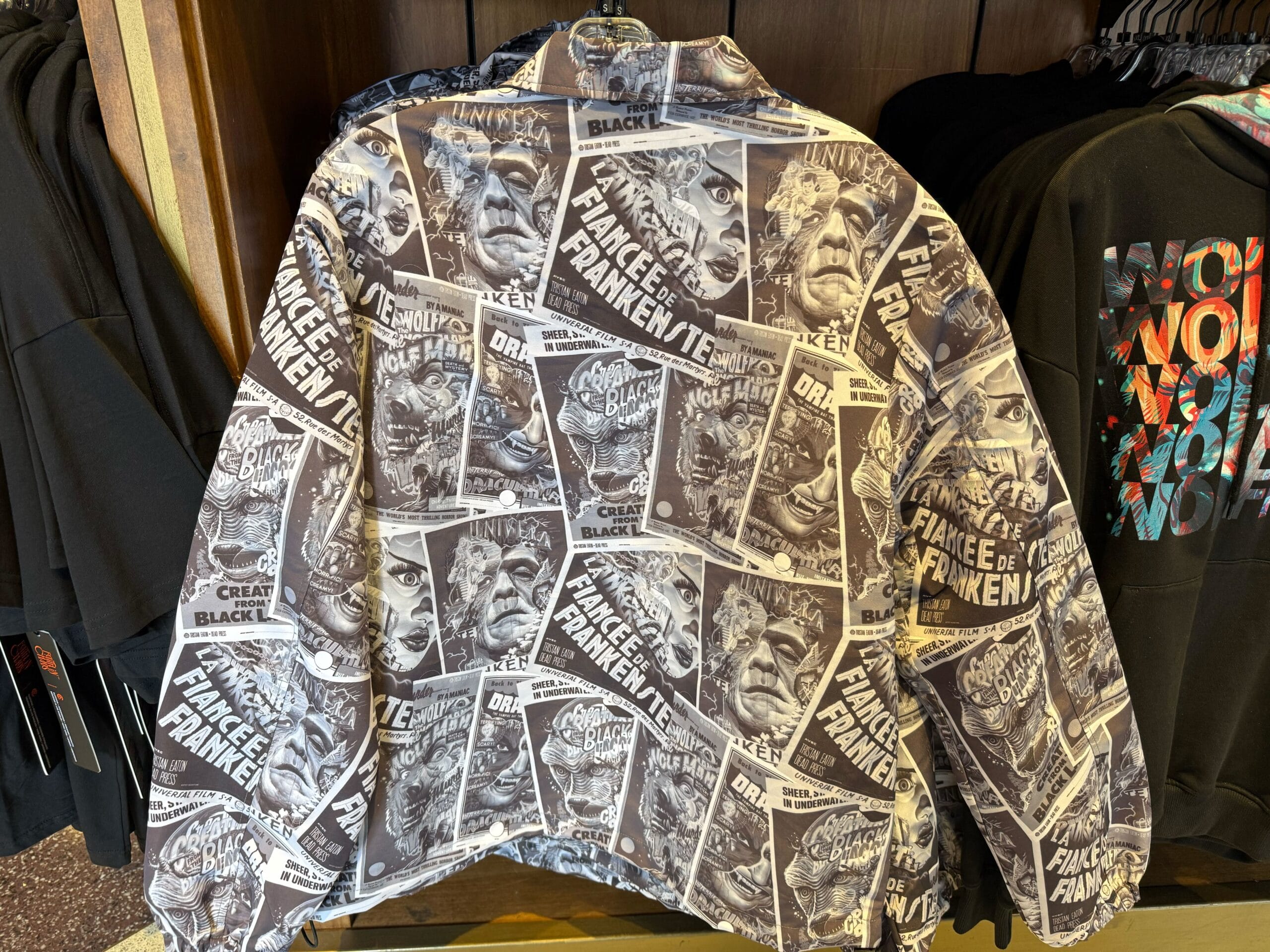 Jacket featuring black-and-white horror movie posters, evoking vintage vibes—no Disney park castles like Cinderella or Sleeping Beauty here.
