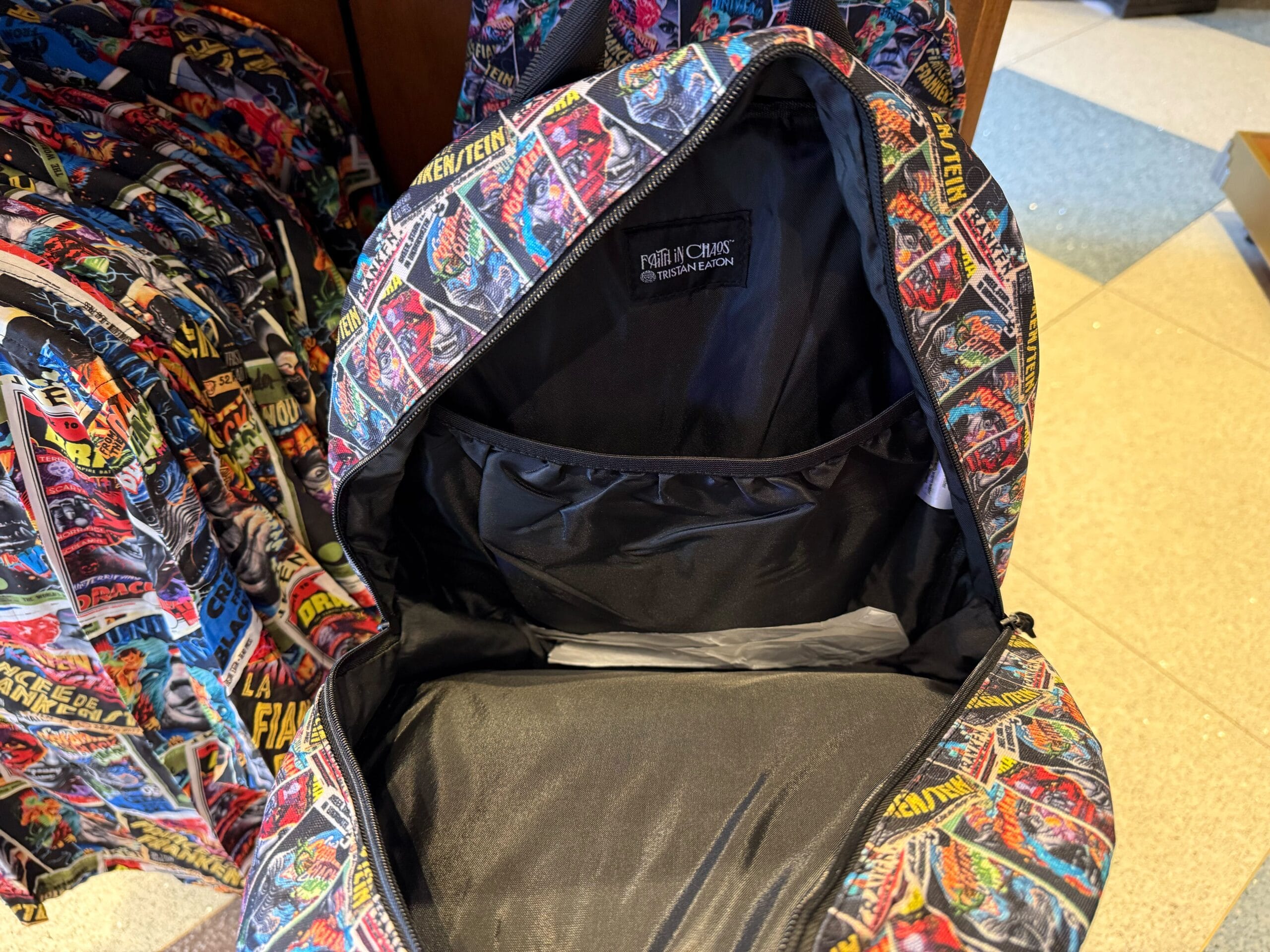 Open backpack with vibrant, comic-style monster print, reminiscent of fun Disney Parks merch, from the Universal Monsters line.