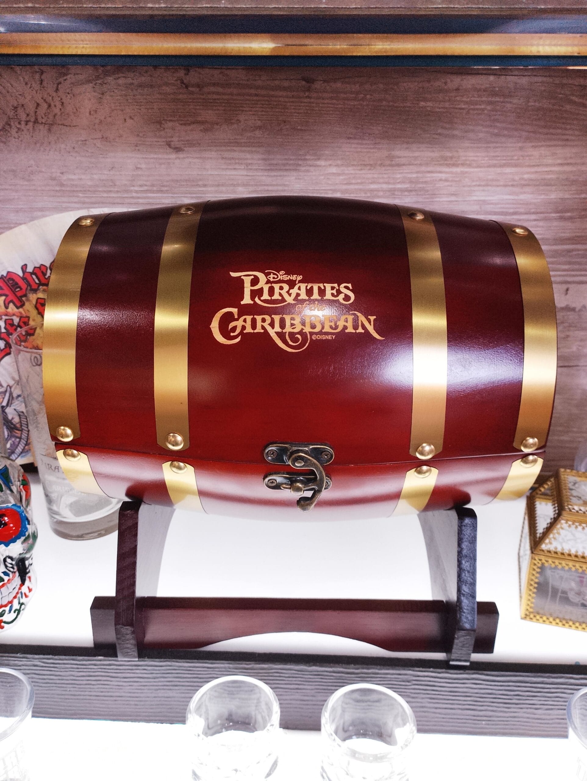 A decorative wooden chest labeled "Disney Pirates of the Caribbean" with gold accents, reminiscent of treasures from Disney parks.