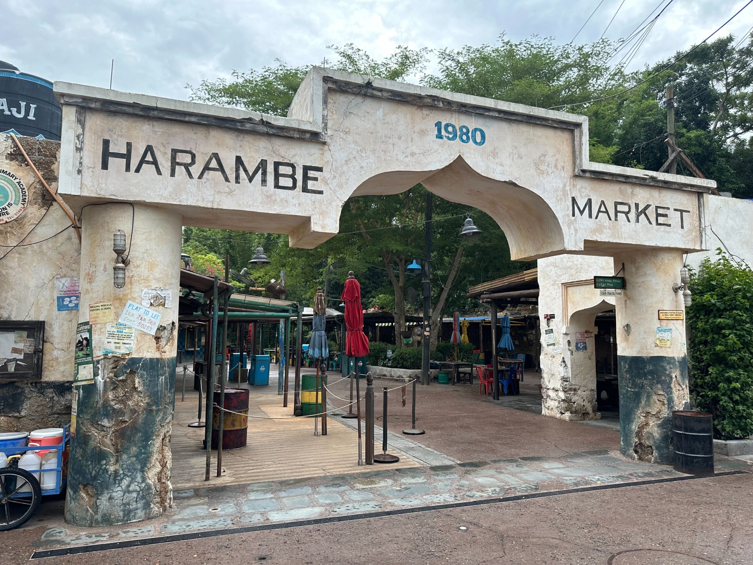 Arched gateway entrance to Harambe Market with weathered walls and “1980” above in Disney's Animal Kingdom.