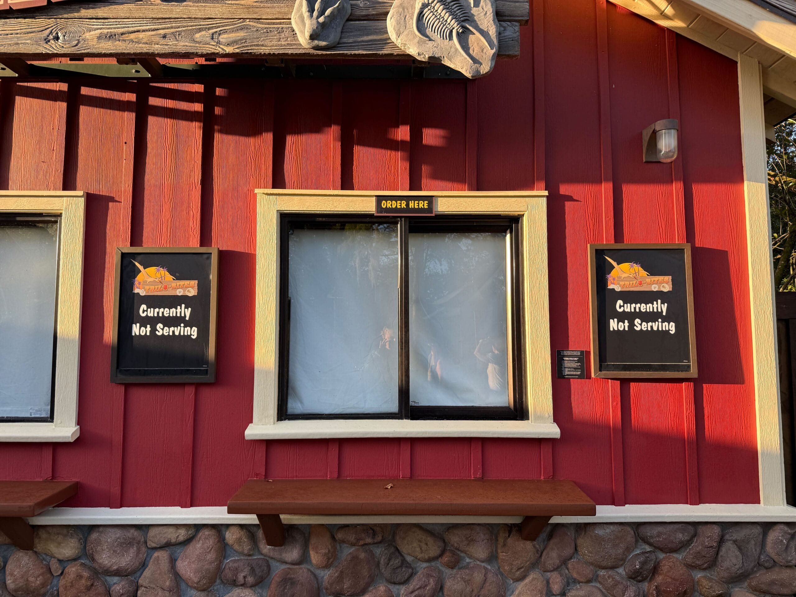 Dino-Bite Snacks’ closed window at Animal Kingdom, displaying "Currently Not Serving" signs—no Mickey treats here today.
