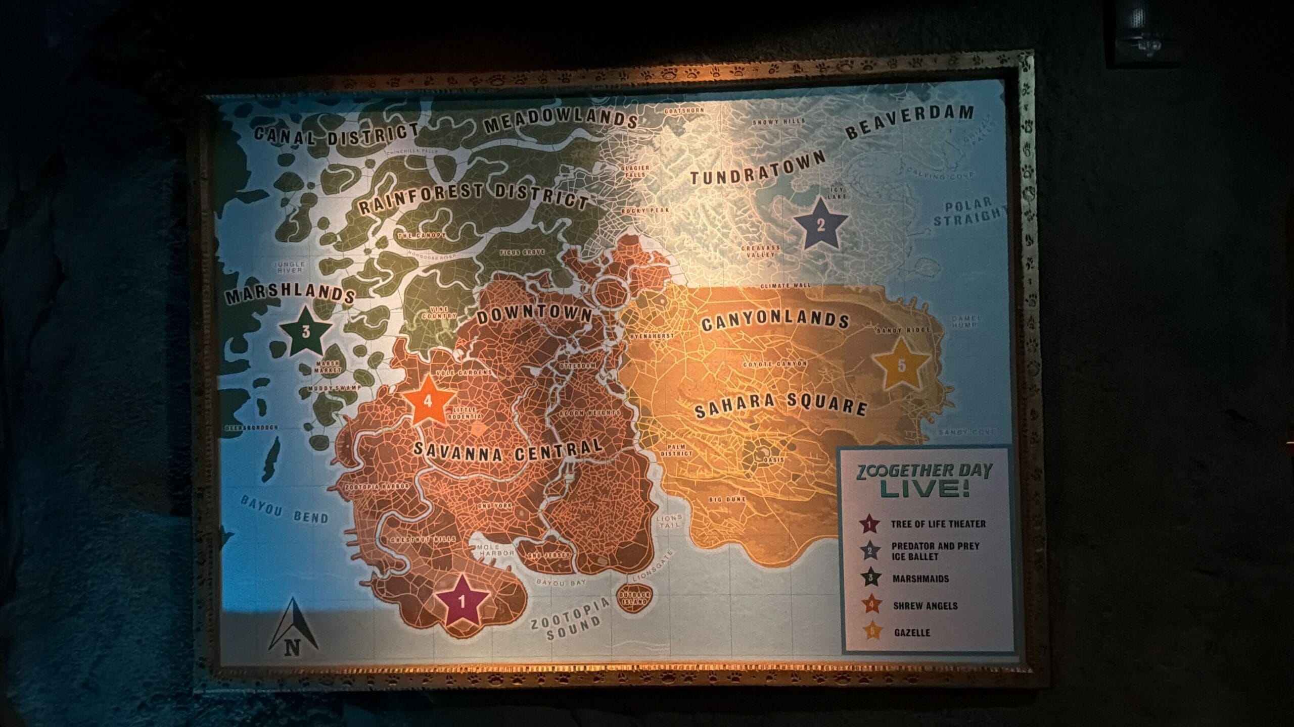 A themed Zootopia map with Downtown, Marshlands, Savannah Central and stars marking spots—no Disney castle like in park maps.