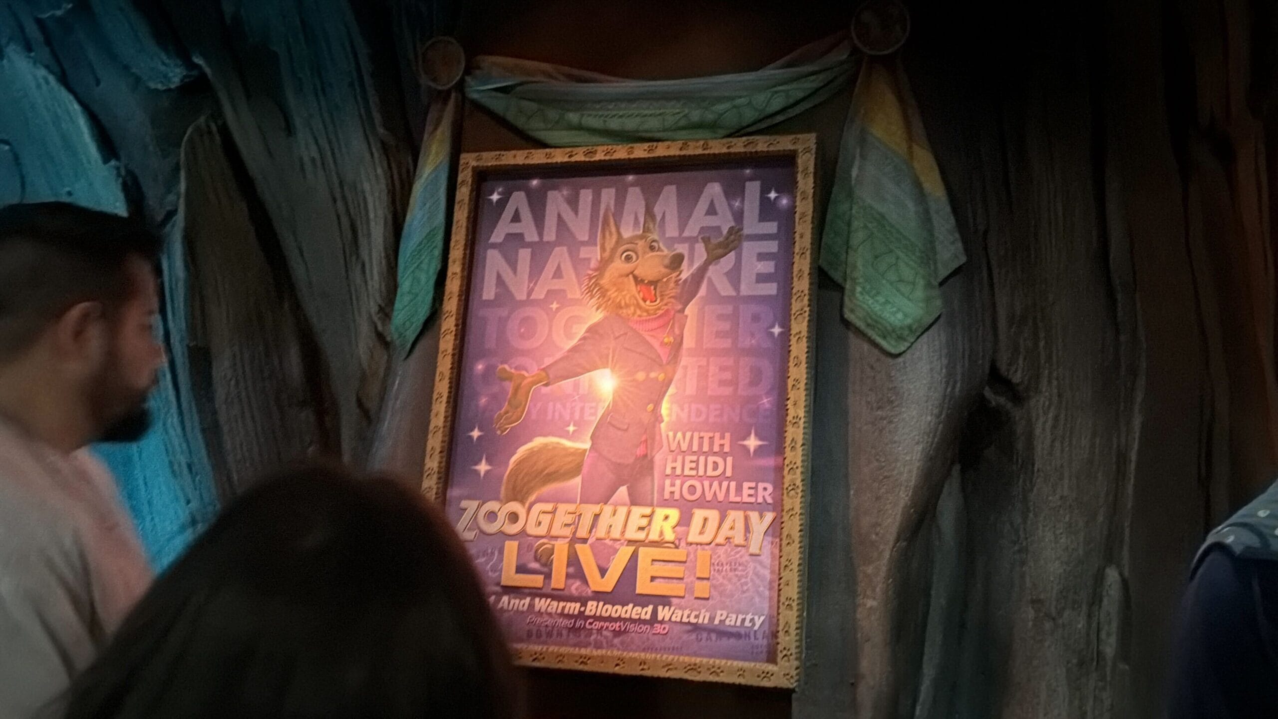 Poster for "ZooGether Day Live!" with animated wolf Heidi Howler; reminiscent of Disney event banners, people gather nearby.