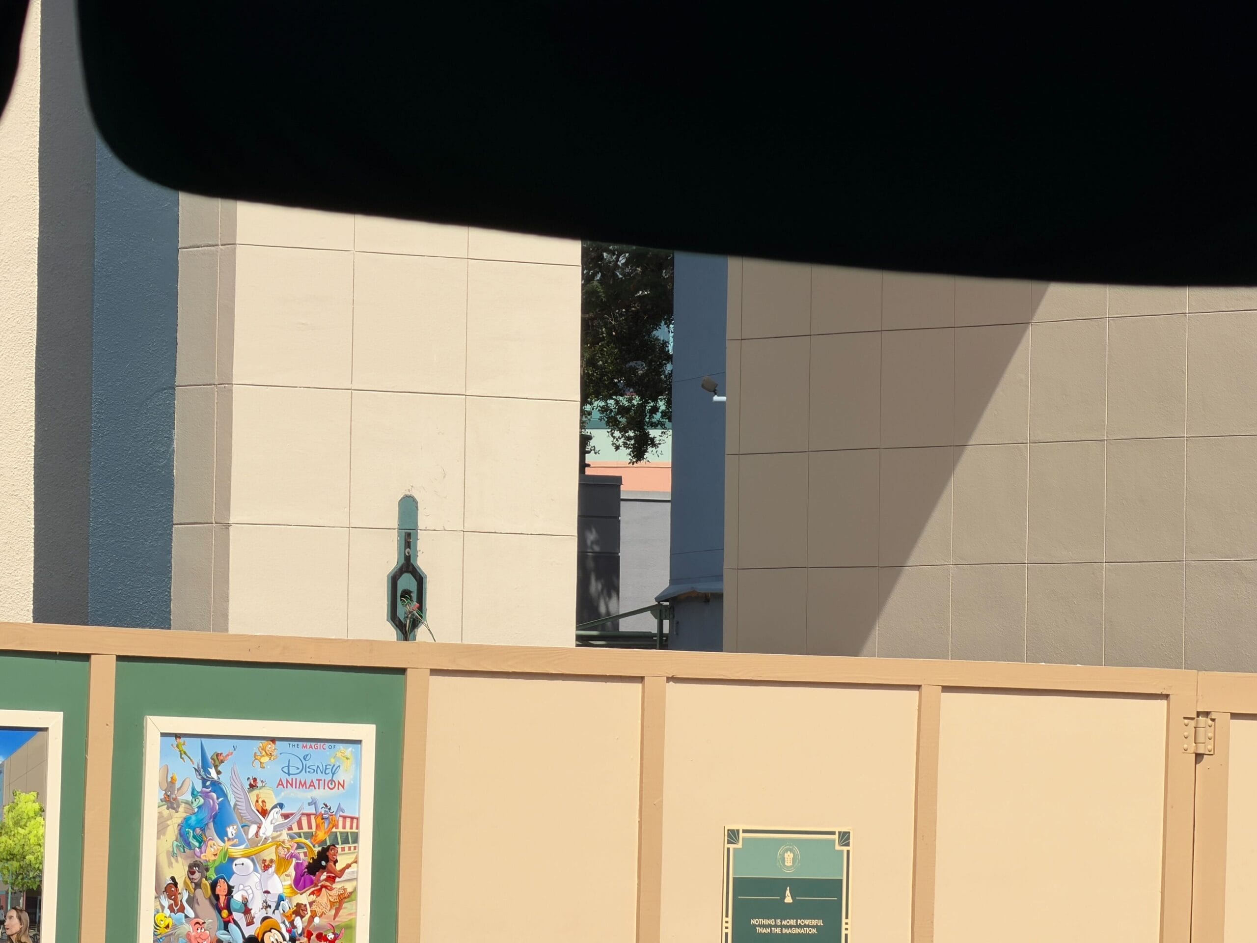 A Disney-themed construction wall blocks part of Star Wars Launch Bay at Hollywood Studios, sign missing, no castle pictured.