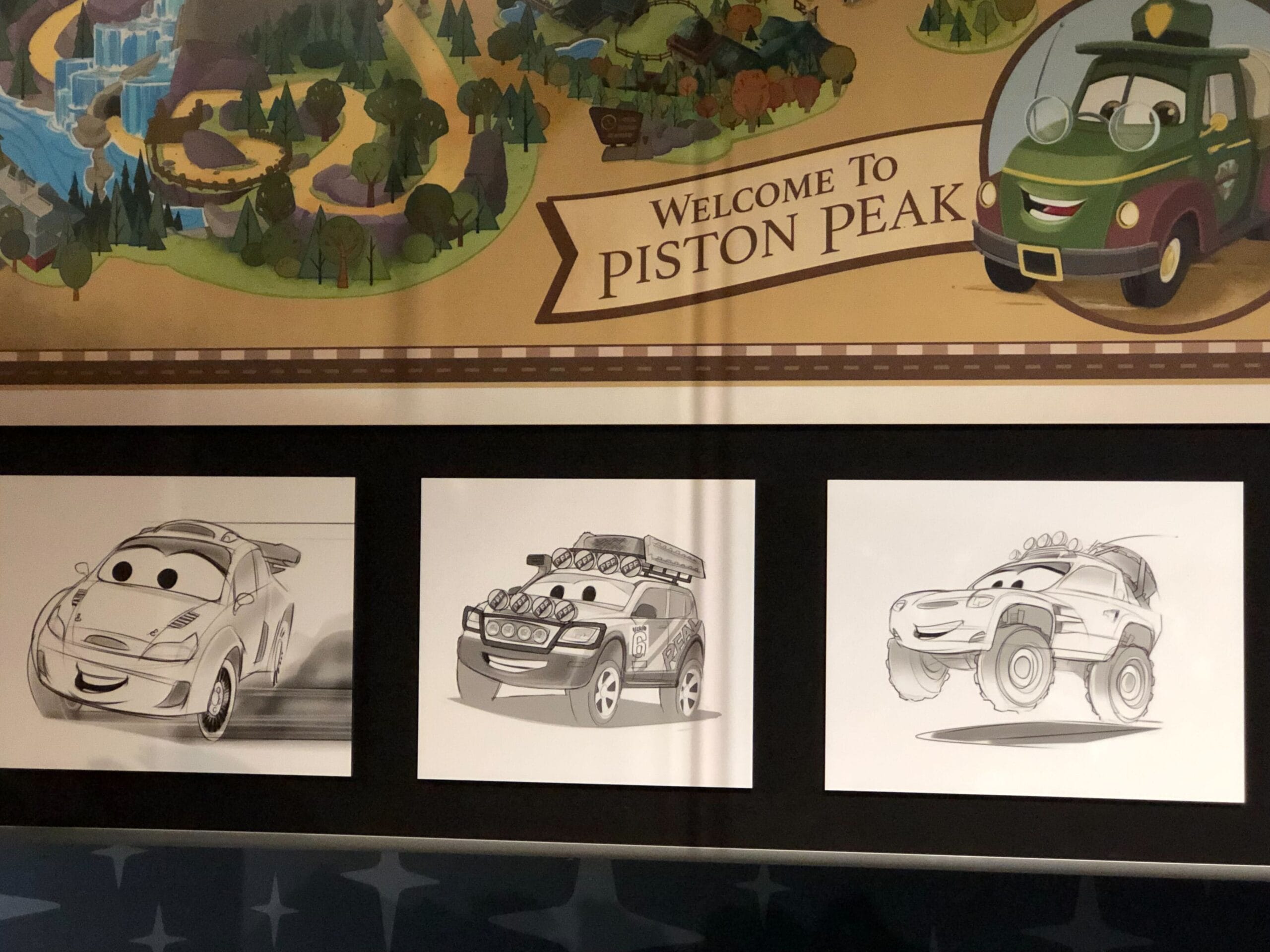 Three black-and-white sketches of smiling, wide-eyed cars greet guests at Cars Land, similar to Disney’s cheerful park entrances.