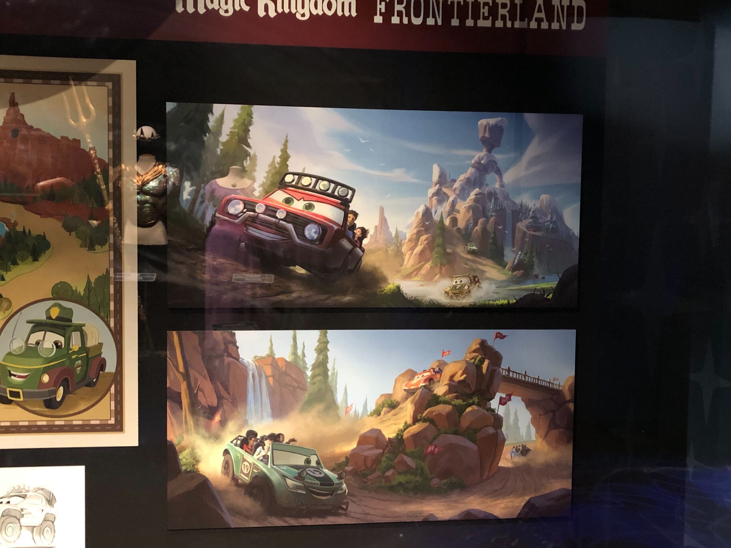 Cartoonish vehicles navigate rocky mountains in Cars Land, capturing the vibrant adventure of a Disney park landscape.