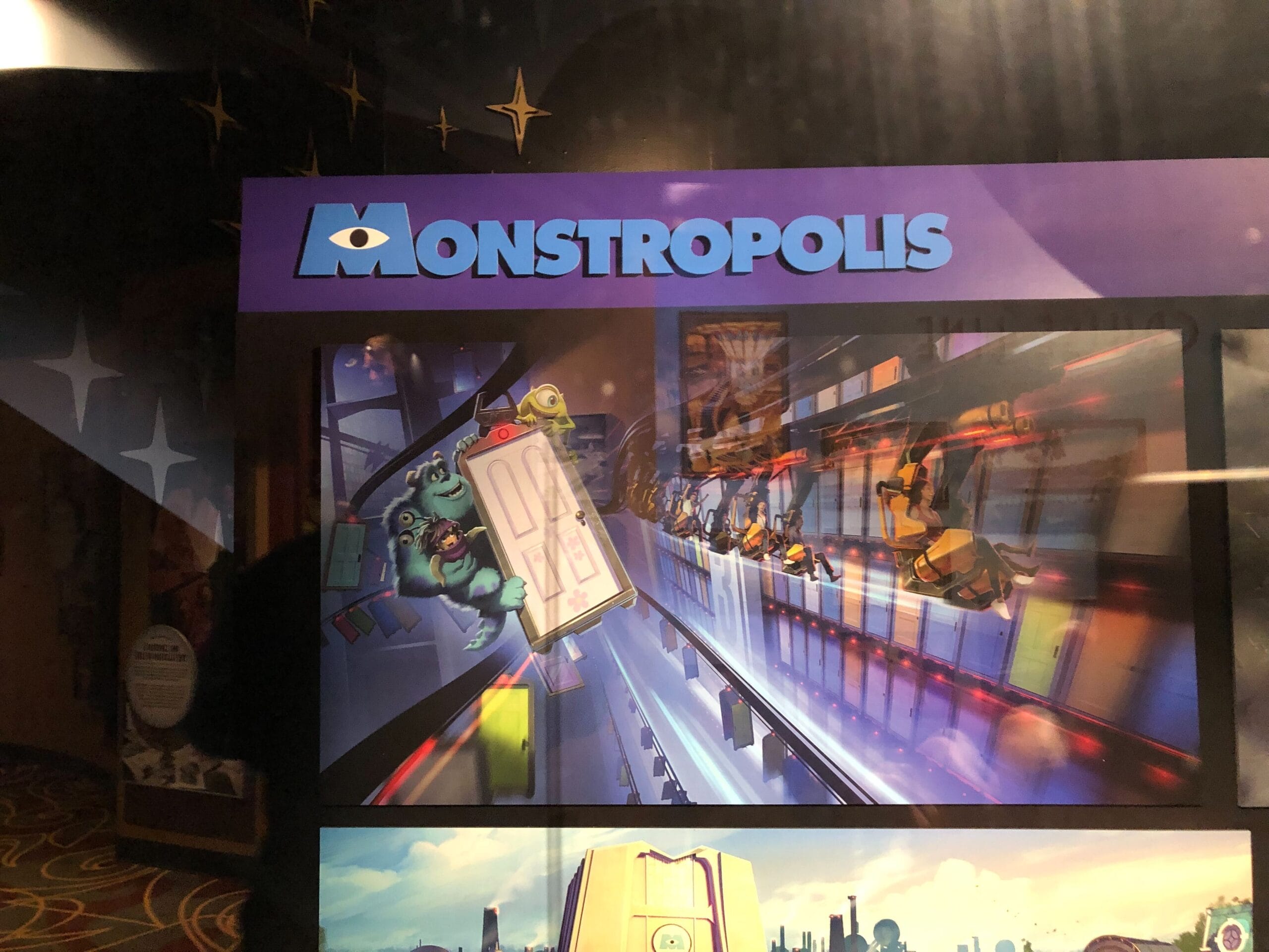 A "Monstropolis" display from a Disney park, showing cartoon monsters chasing a door, reminiscent of Monsters Inc. Coaster.