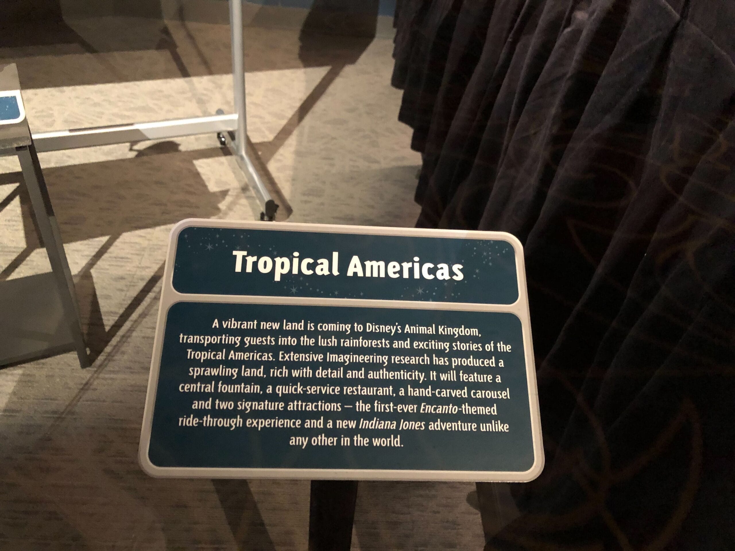 Sign announcing "Tropical Americas," a new themed land coming to Animal Kingdom, with experiences unlike any Disney park castle.