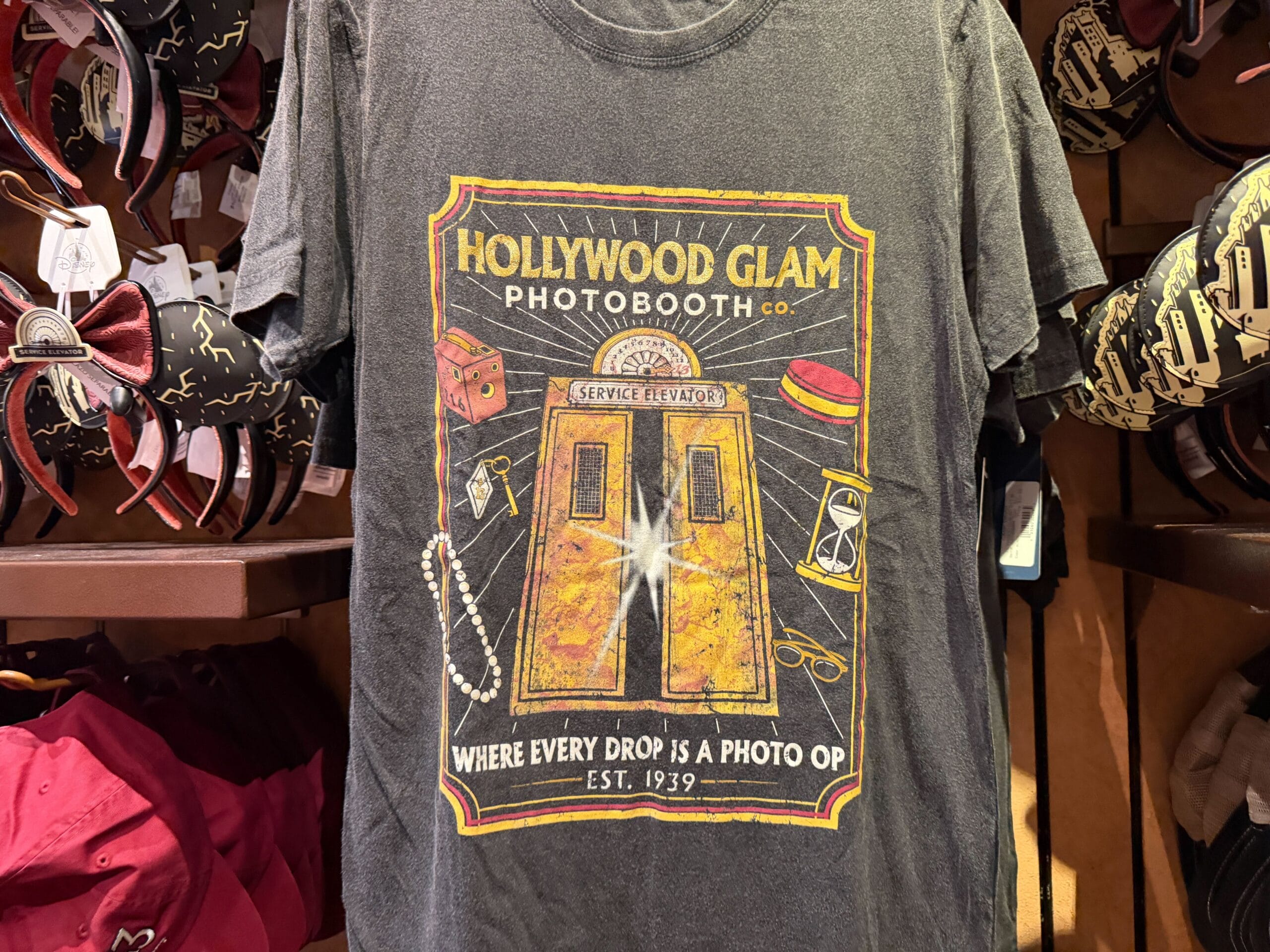 Gray T-shirt with a Hollywood Glam Photobooth design, echoing Hollywood Studios at Disney, with elevator doors and vintage props.
