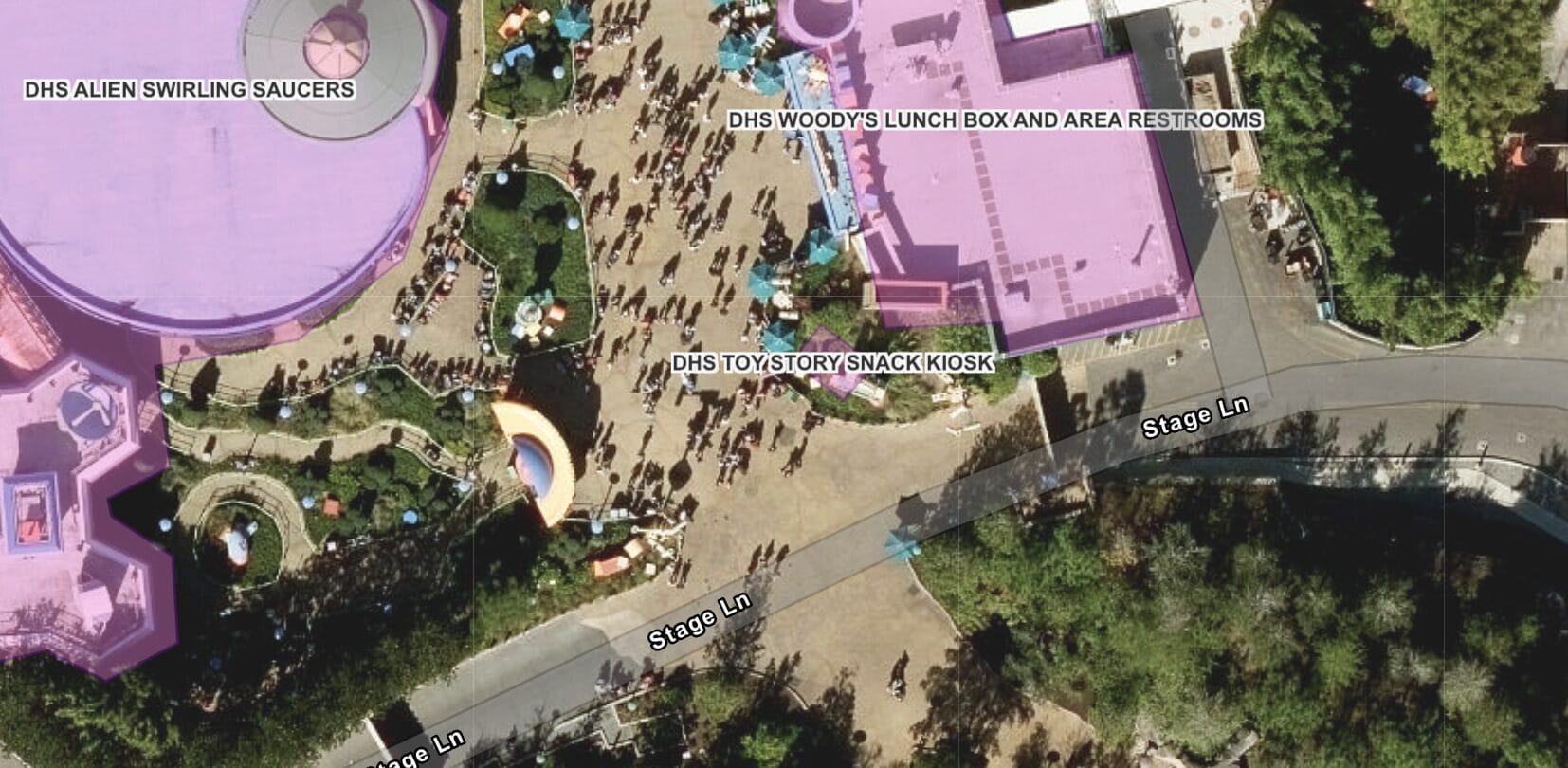 Aerial view of Disney’s Toy Story Land, highlighting attractions, pathways, crowds, and a snack kiosk among the buildings.