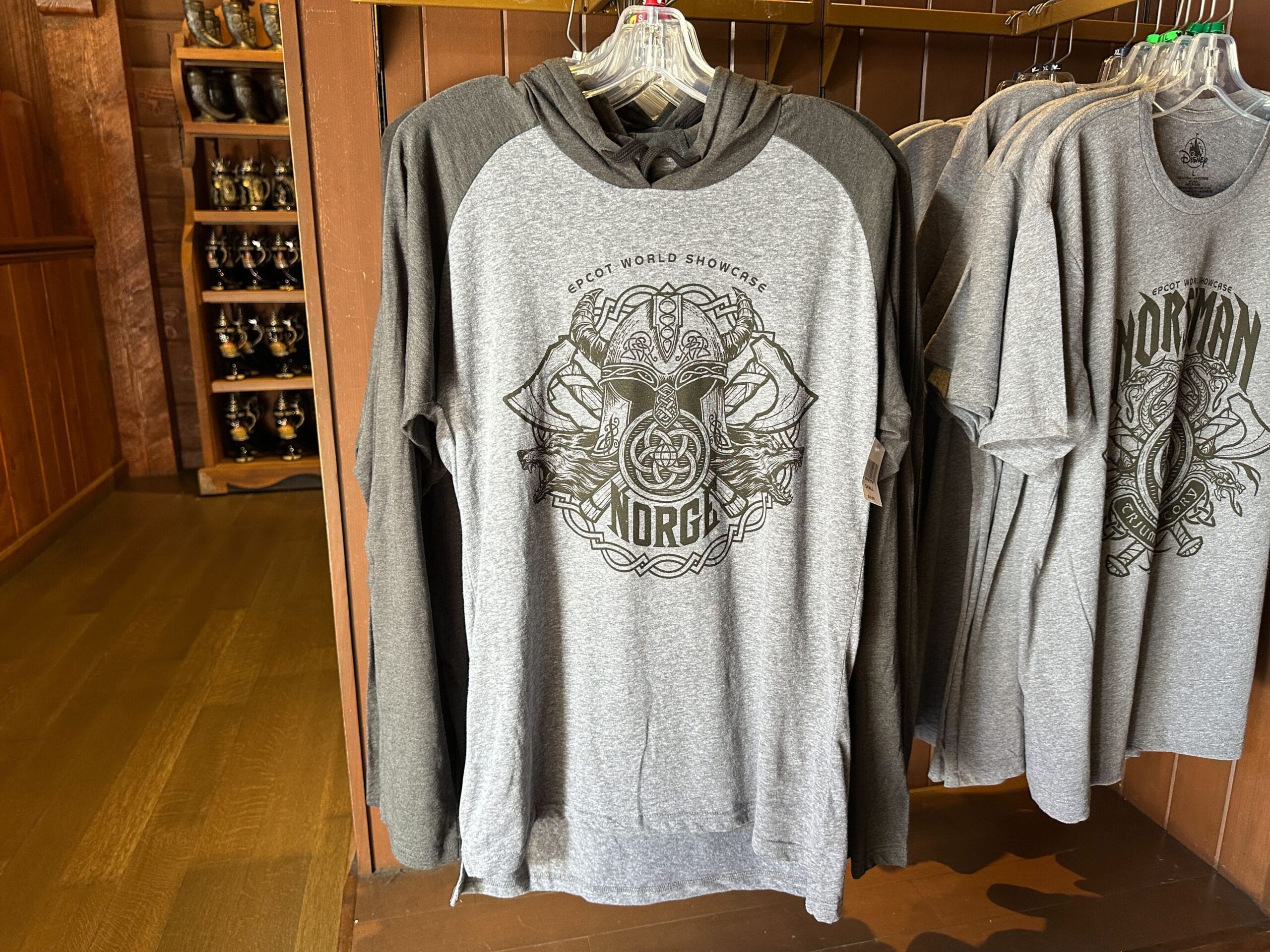 A gray hoodie featuring a Viking helmet and Norse design, labeled "Norge," hangs in a store in Epcot’s Norway Pavilion.