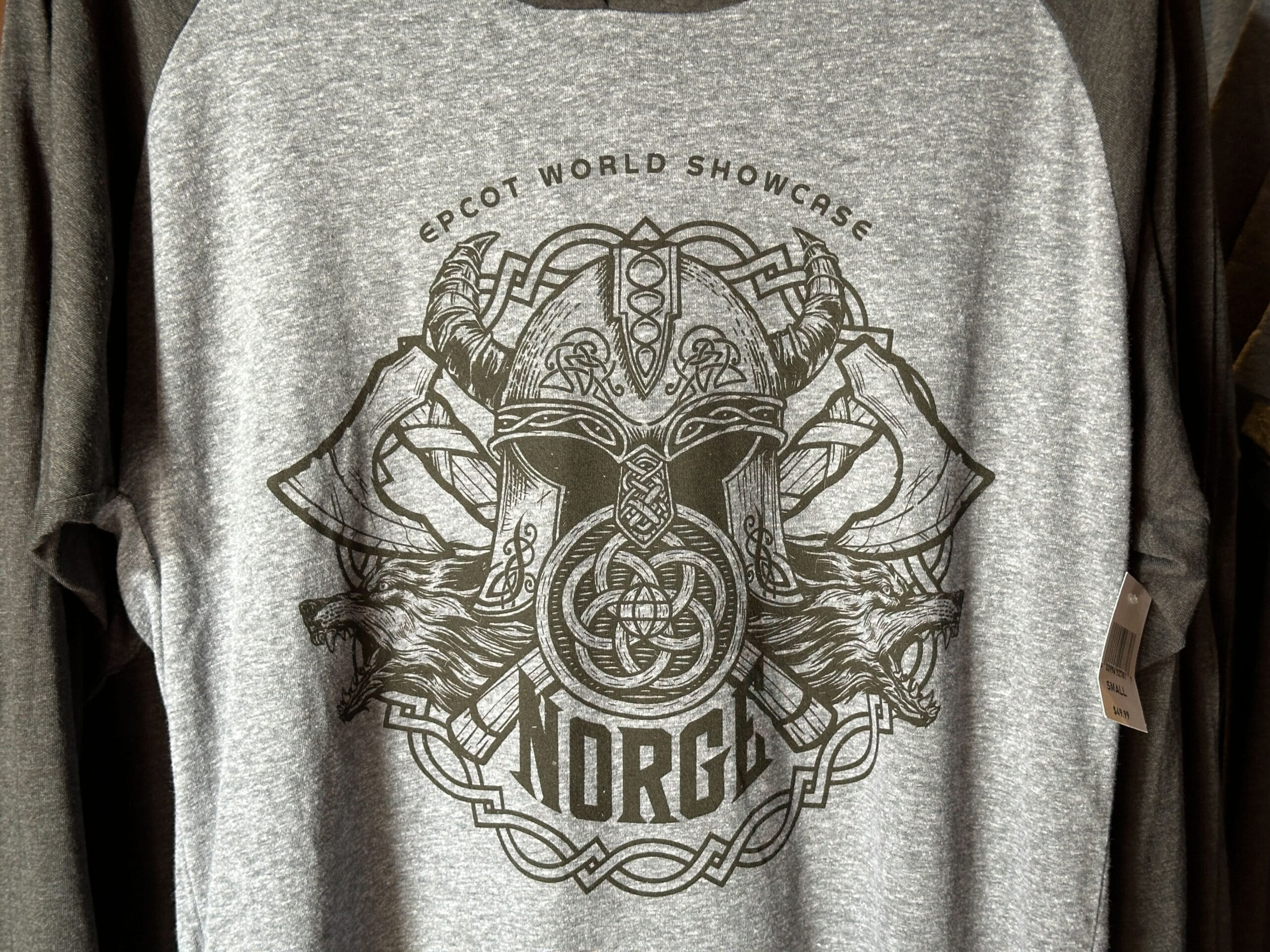 Gray shirt featuring Viking helmet, axes, and wolf; text says "Epcot World Showcase Norge," referencing Disney's Norway pavilion.