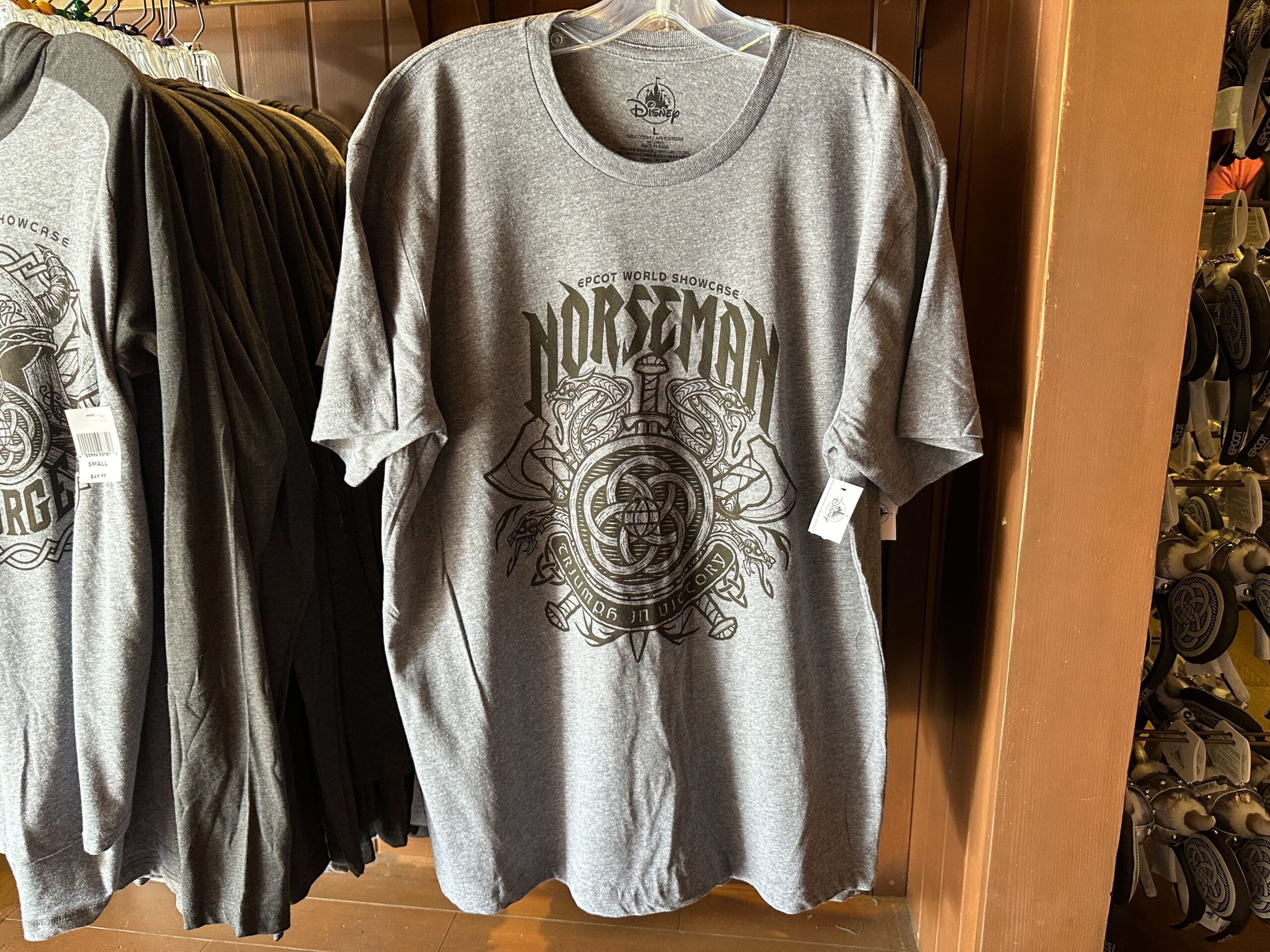 Gray t-shirt featuring "Norseman" and Viking graphic on a hanger in a store in Epcot's Norway Pavilion.