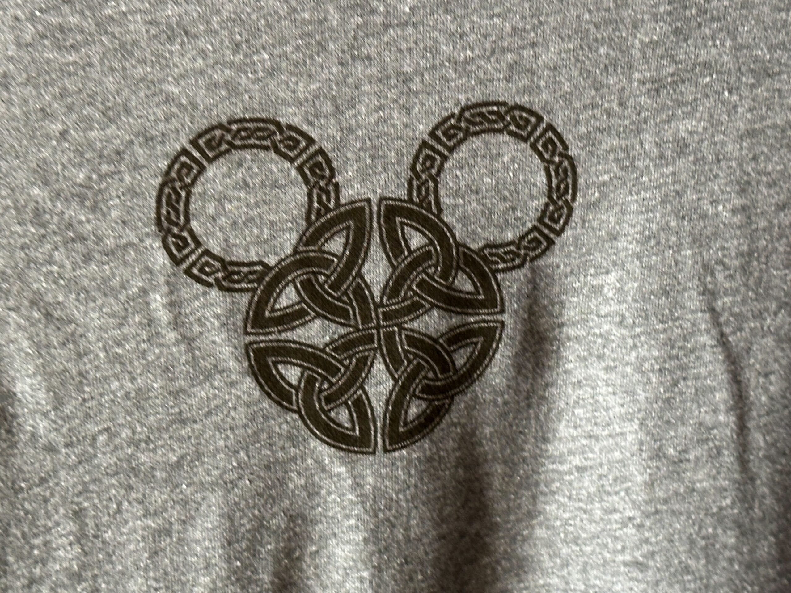 Close up of gray shirt featuring a black knotwork Mickey Mouse head design.