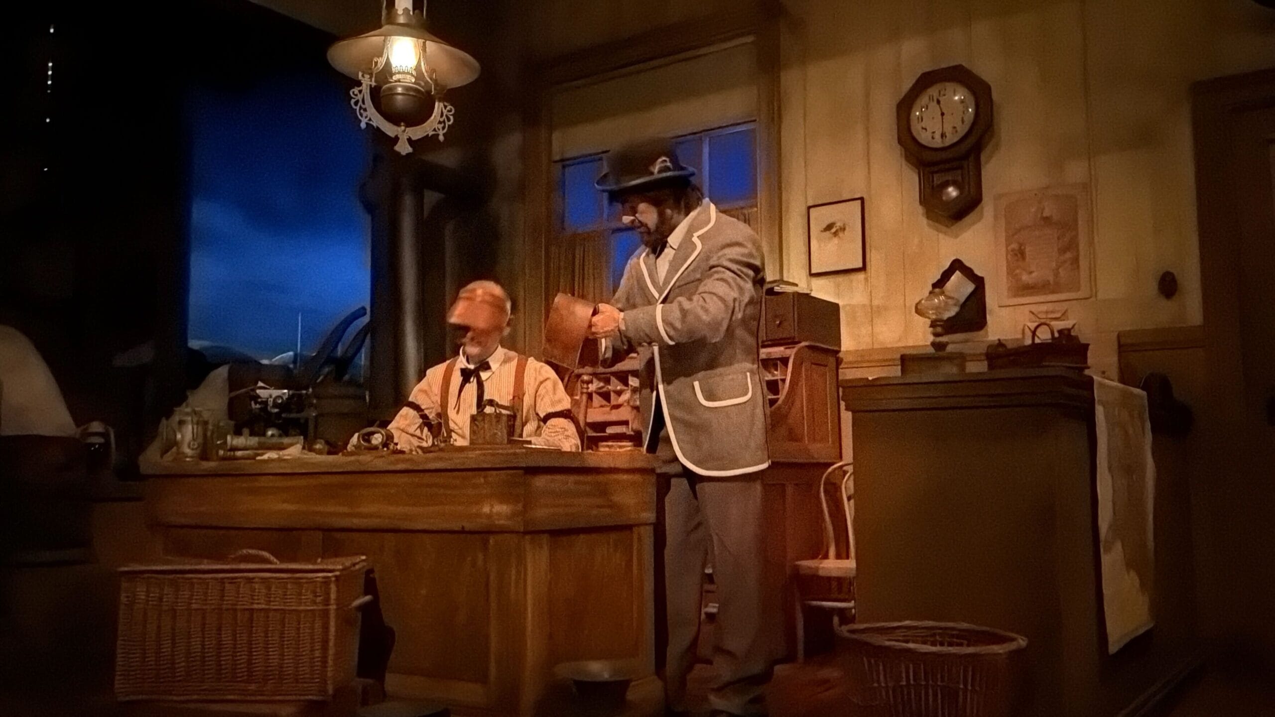 Two men in vintage attire work in a refurbished old office, echoing Main Street U.S.A.’s turn-of-the-century Disney park style.