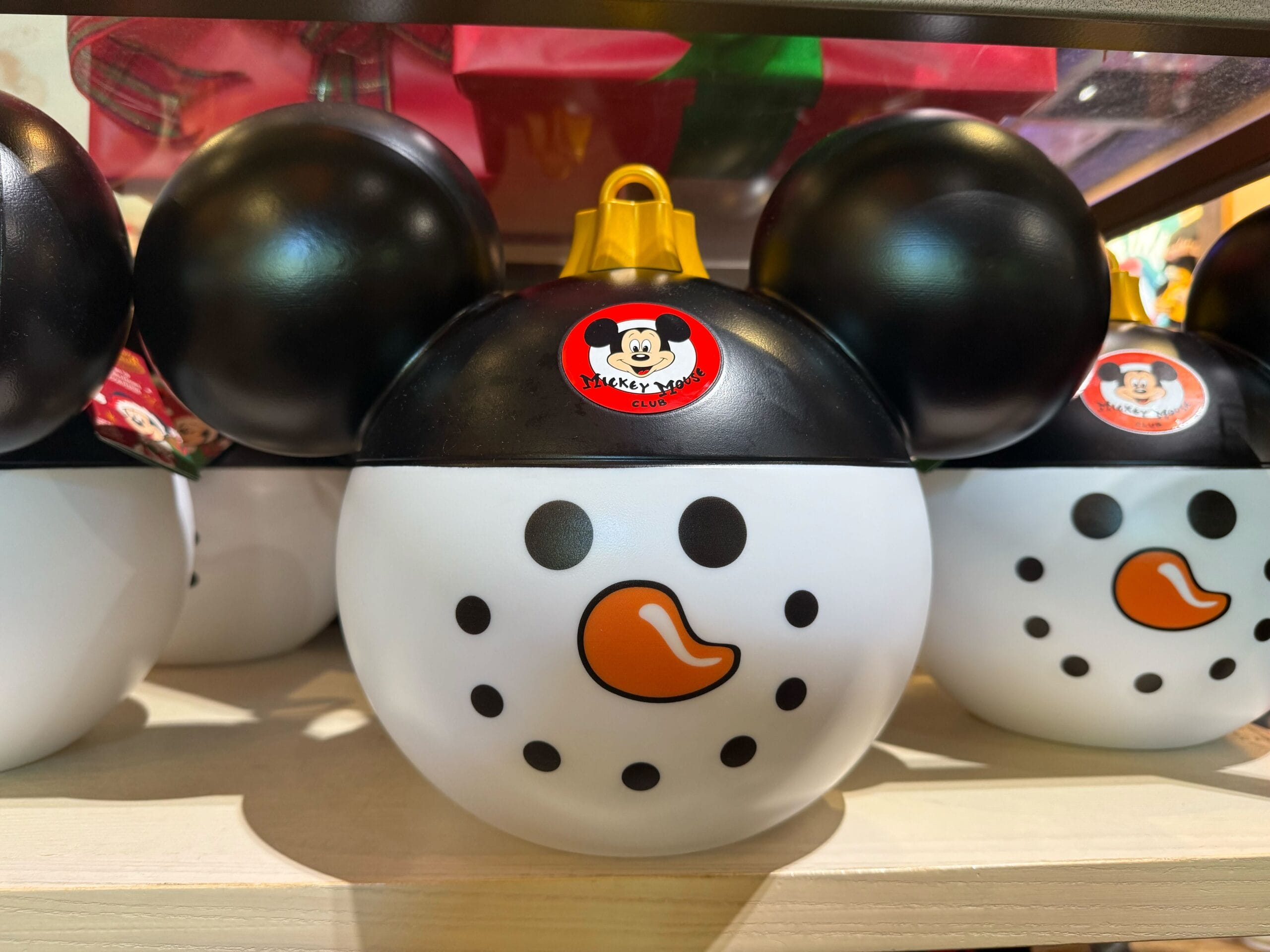 Snowman-shaped round container with Mickey ears, exclusive to Disneyland Resort's holiday line; no castle, so none to compare.