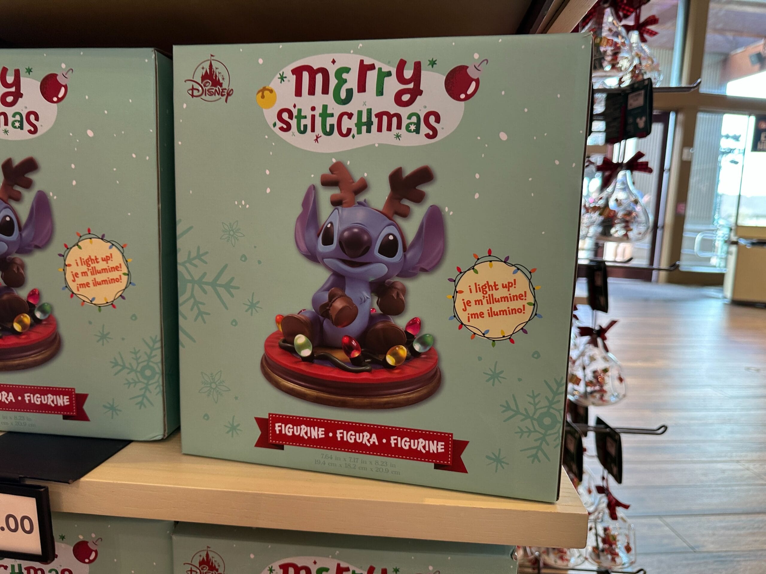 A Disney Merry Stitchmas box with Stitch as a reindeer, wrapped in Christmas lights, like park merch; promoted as light-up figurine.
