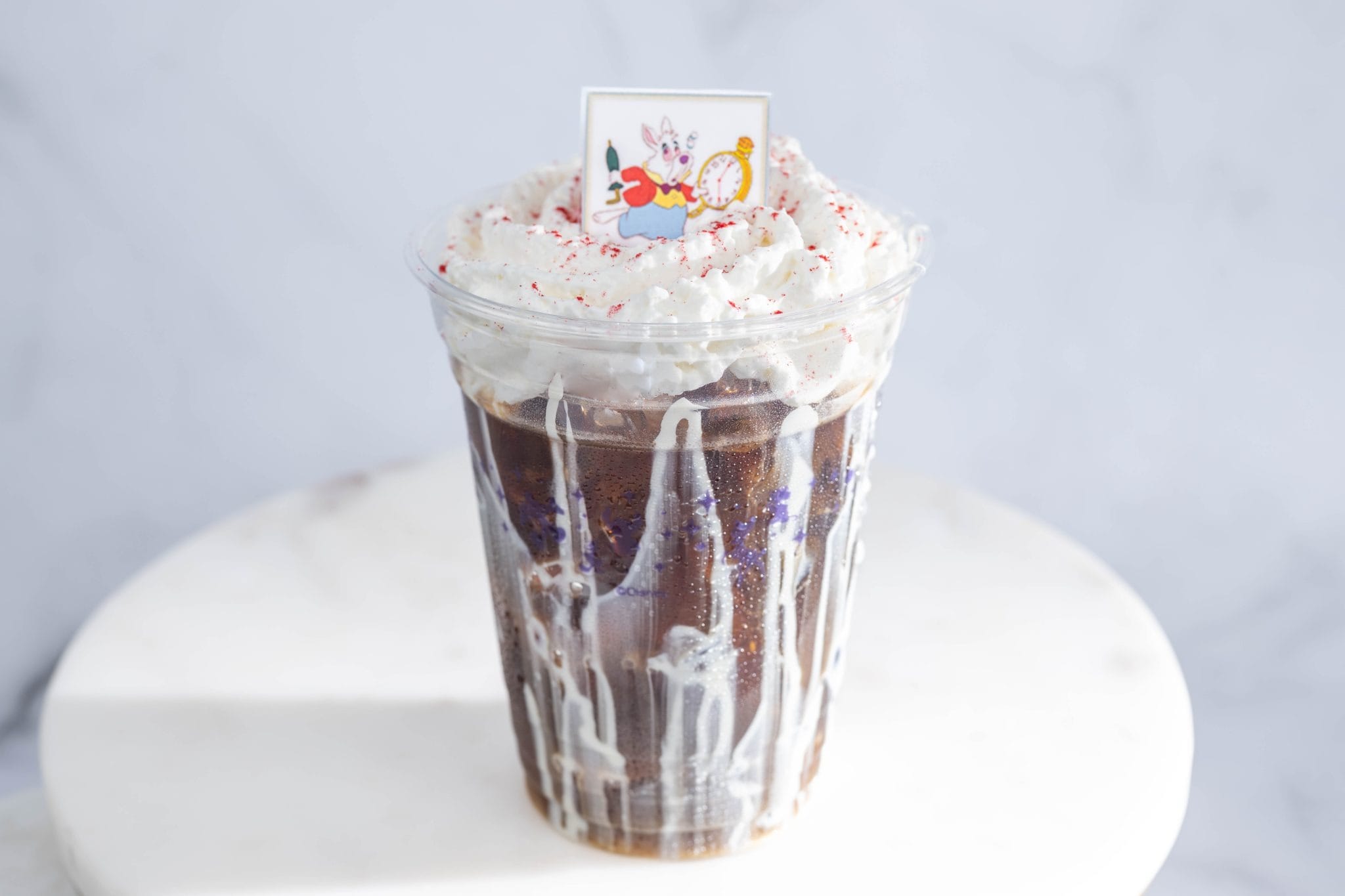 Cold Brew with whipped cream, sprinkles, and a White Rabbit topper in a clear cup—a Walt Disney World delight!