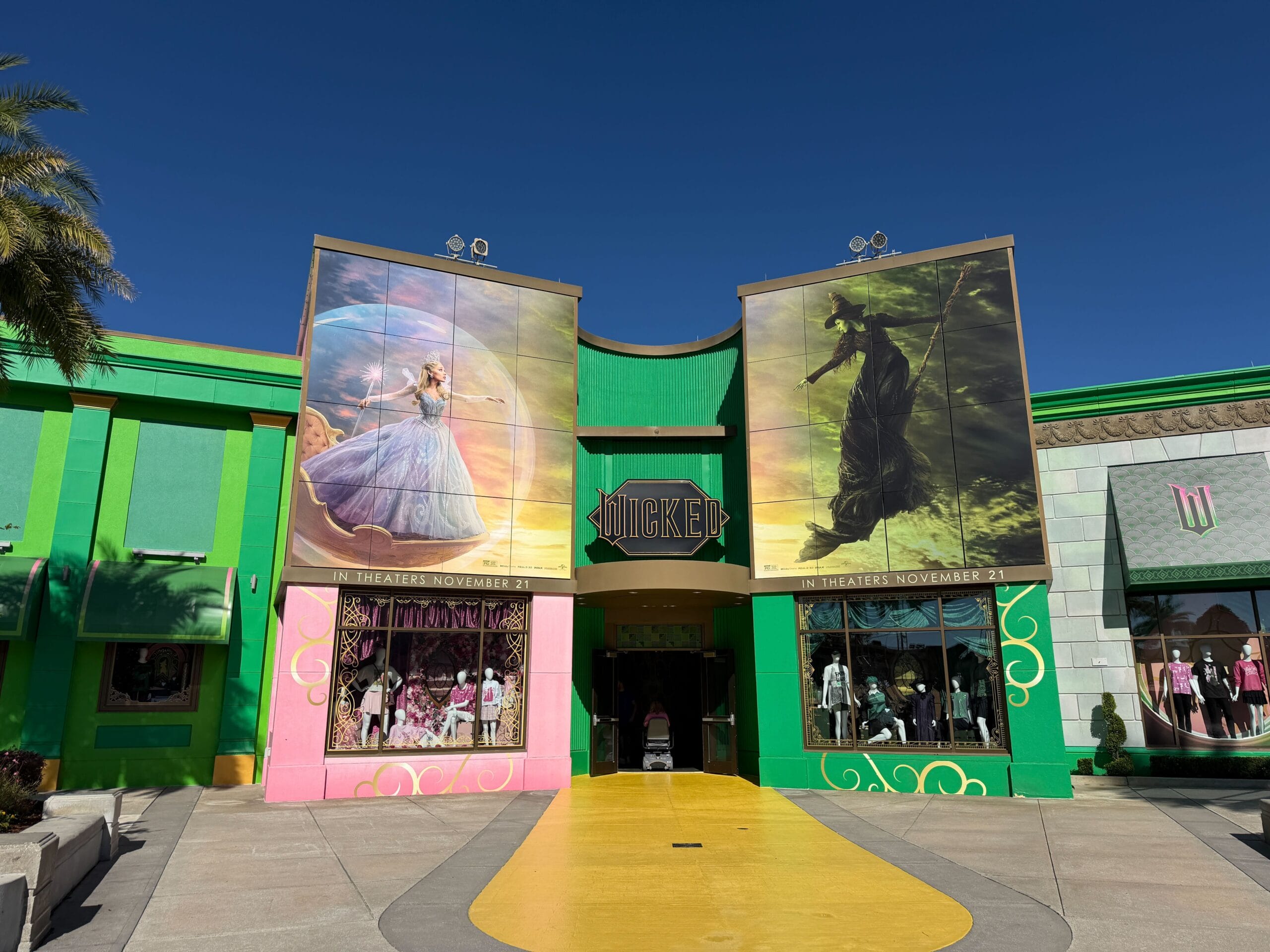 Entrance to a Wicked-themed store, styled like Disney park shops, with witch posters and mannequins, but no castle in sight.