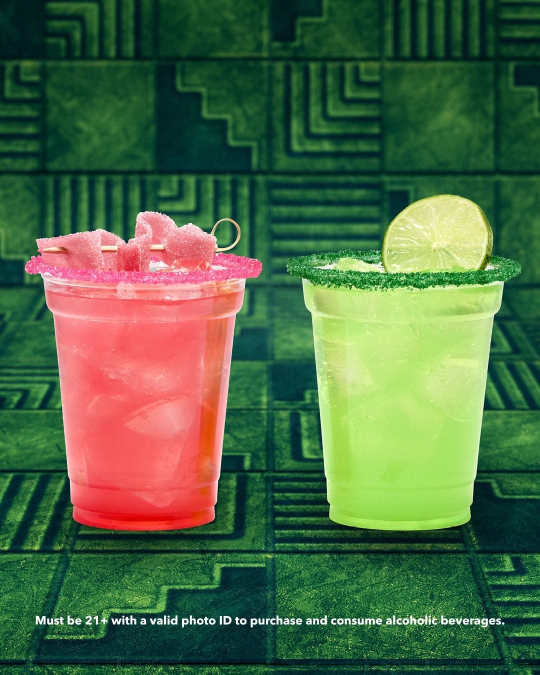 Two vibrant cocktails from Universal Orlando stand out on a vivid green background, not unlike Epcot’s bold festival drinks.