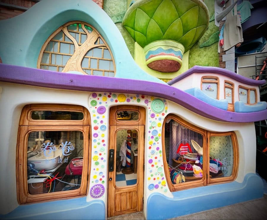 Whimsical sheep barbershop with wavy roof and playful decorations in Zootopia Land at Shanghai Disneyland.