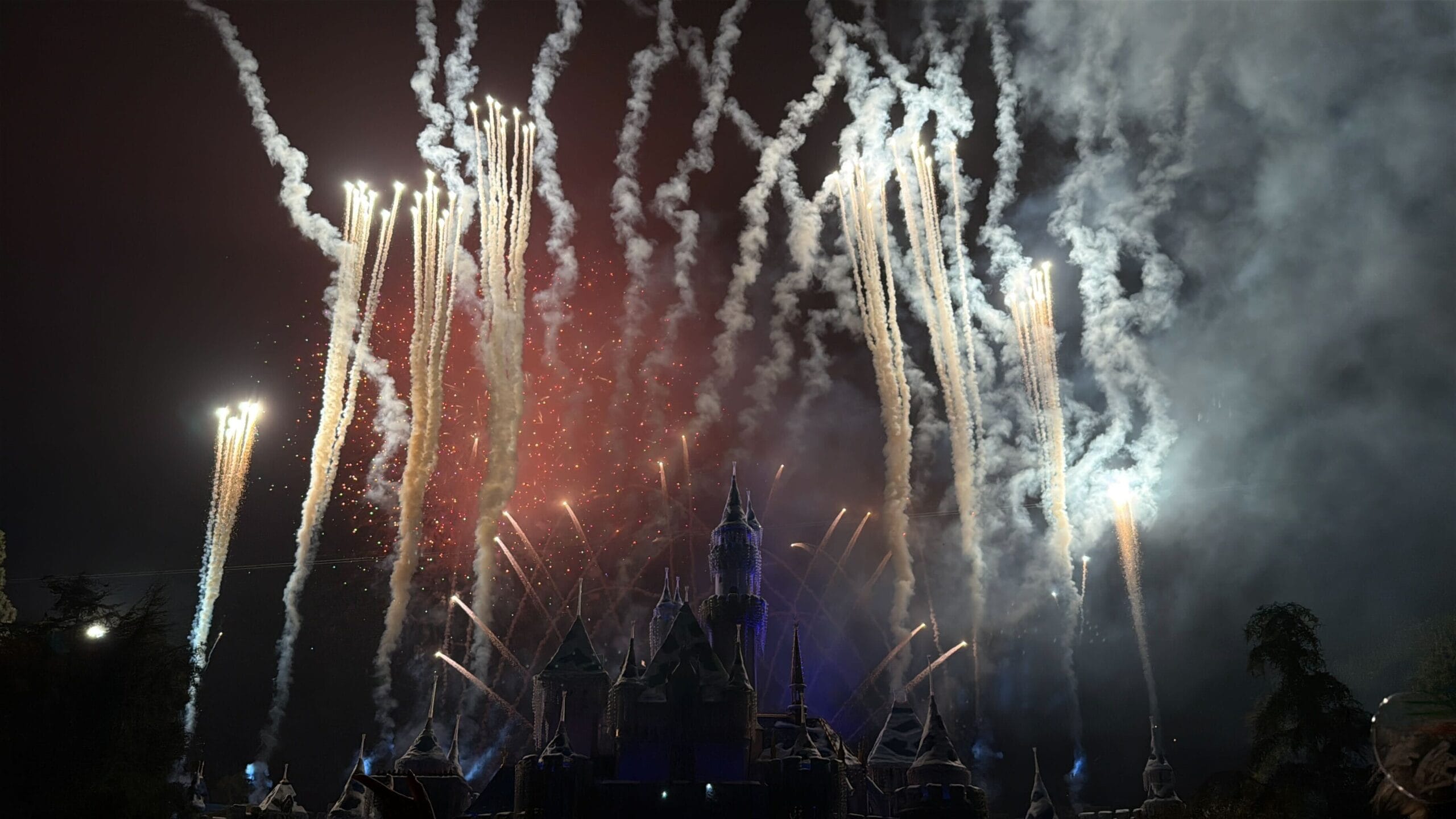 Fireworks light up the night over Disneyland’s castle, its petite spires distinct from Cinderella Castle in Disney World.