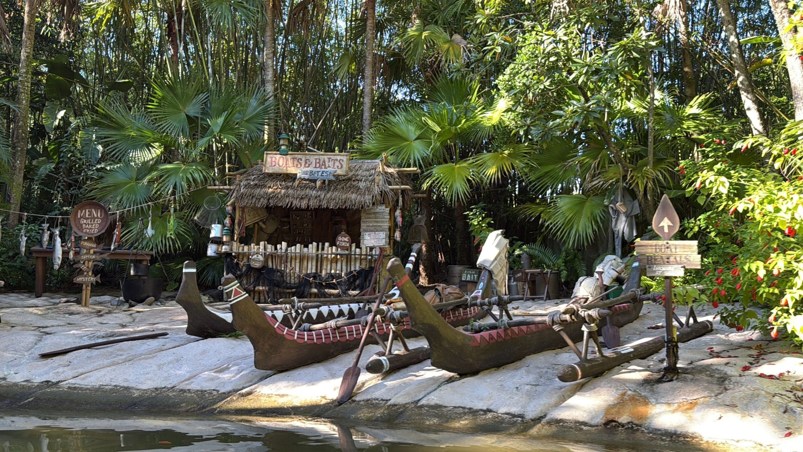 A tropical tiki hut with a "BOATS & BAITS" sign radiates Jingle Cruise vibes, surrounded by lush greenery in Magic Kingdom style.