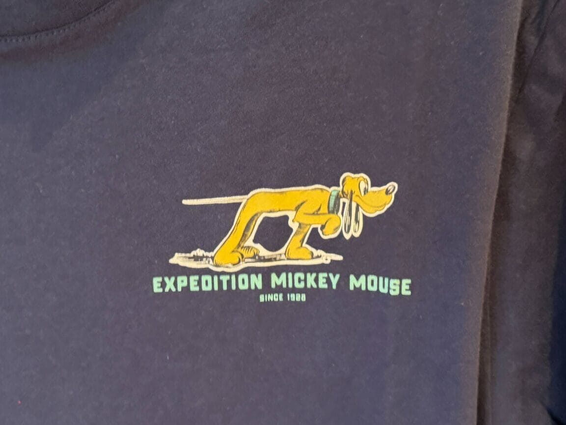 Navy blue shirt with Pluto and "Expedition Mickey Mouse" graphic, inspired by Disney park collections—perfect for park adventures.