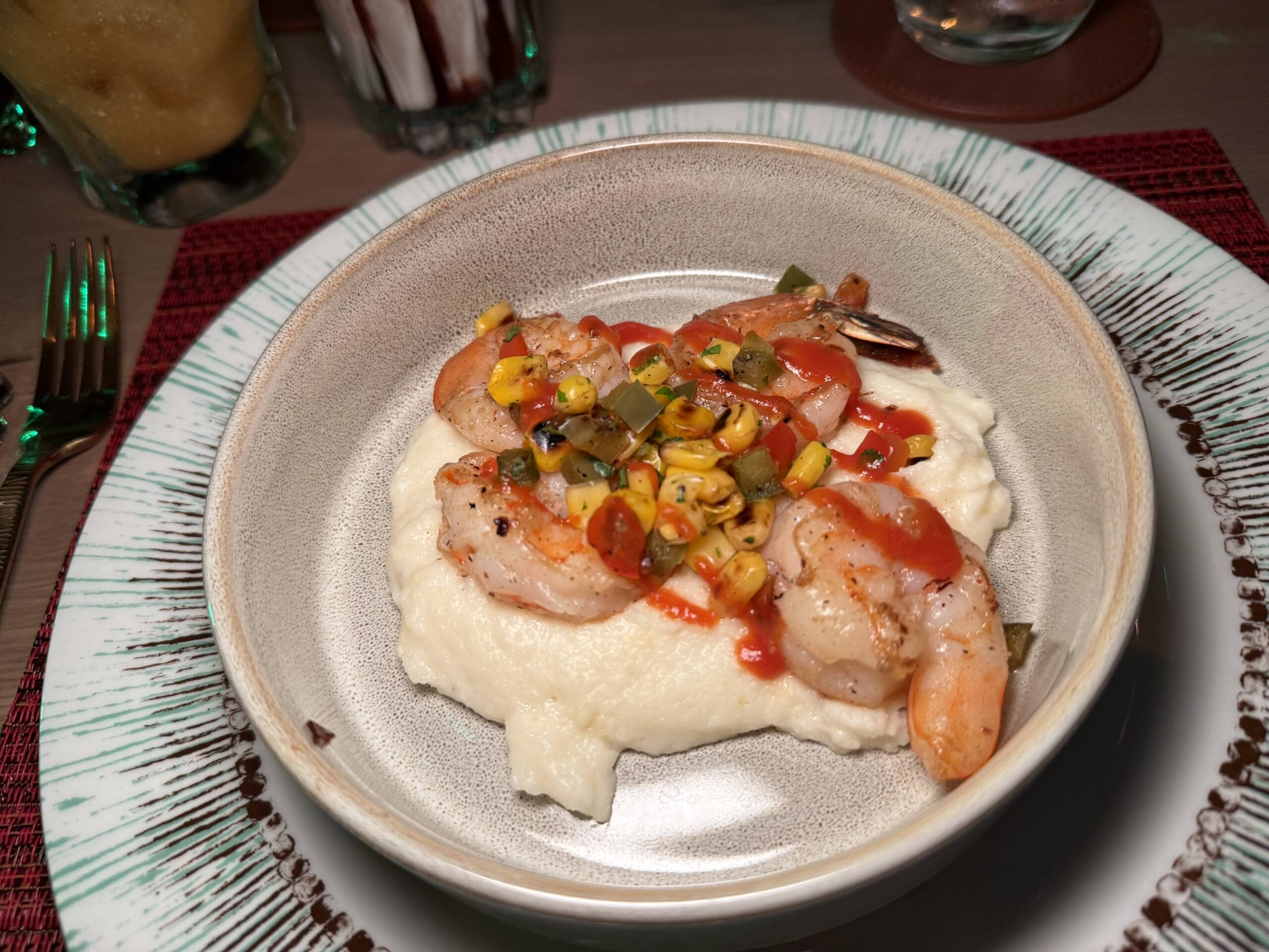 Sauteed Chili-Garlic Shrimp, Creamy Boerenkaas Pap, Toasted Corn, and Peri-Peri Sauce