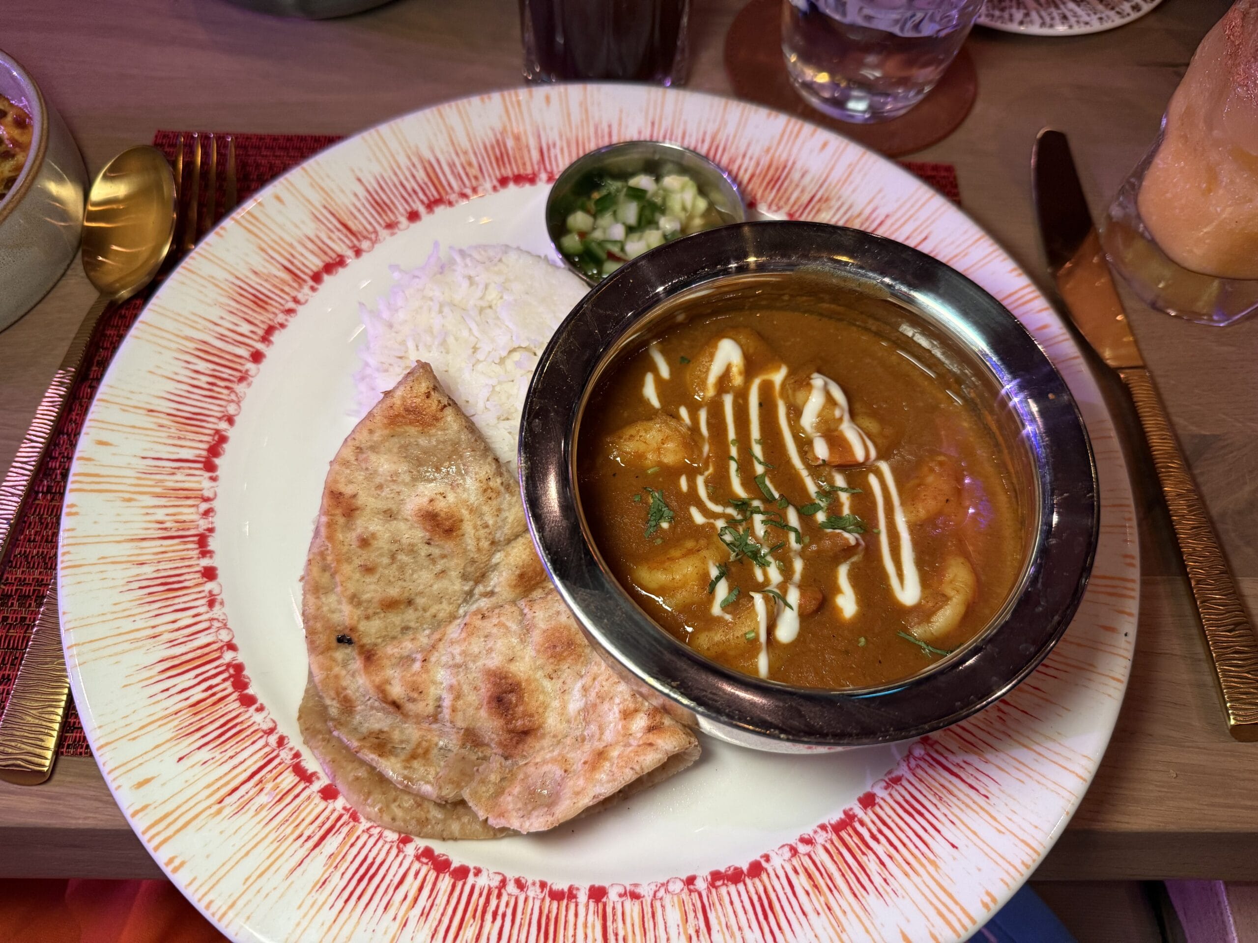Garam masala, Turmeric, Cumin-coconut curry sauce, Aromatic basmati rice, Cucumber sambal, and Butter roti