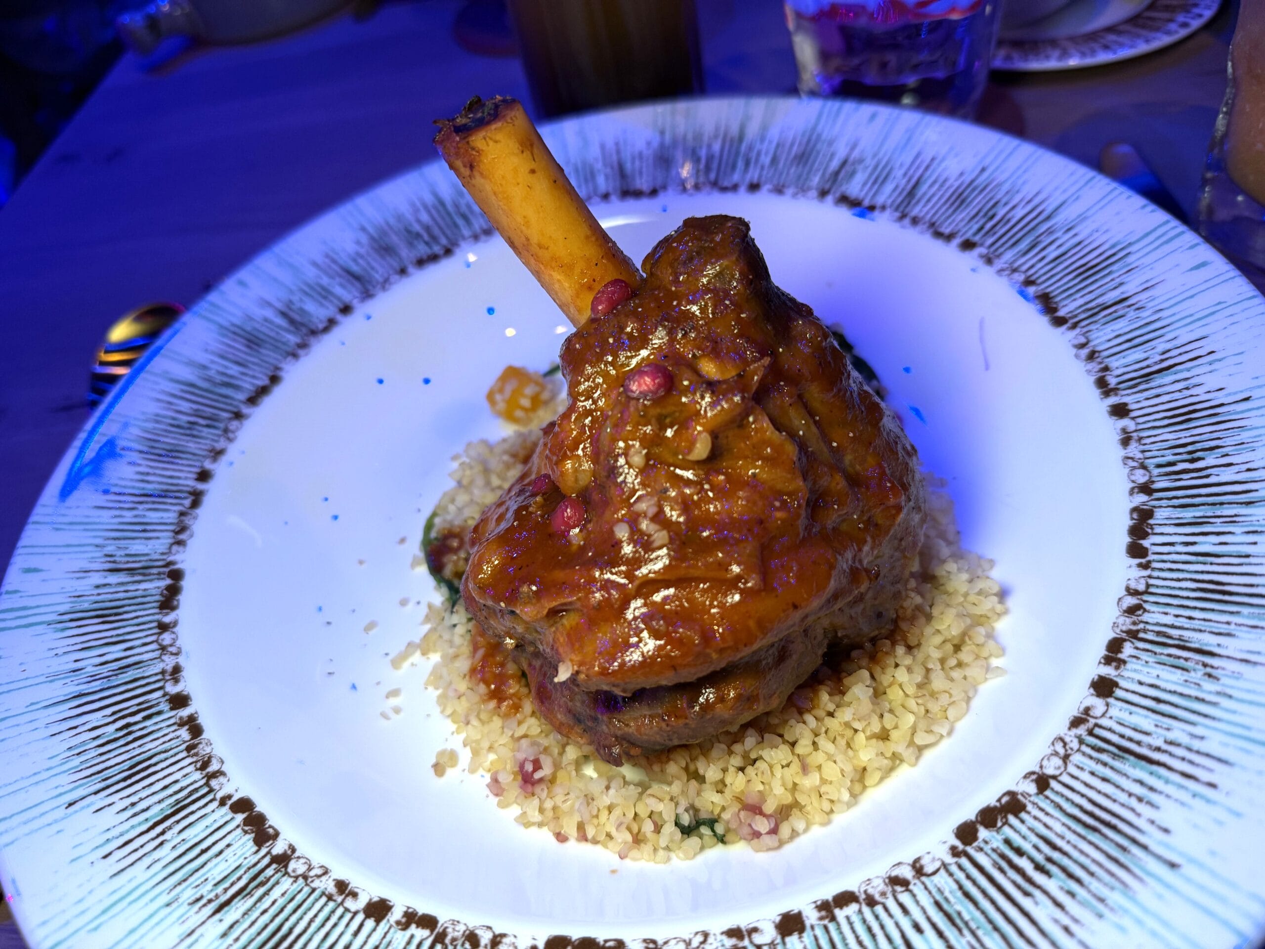 Lamb shank with Cracked Toasted Bulgur Wheat, Mint, Spinach, Summer Squash, and Pomegranate Arils